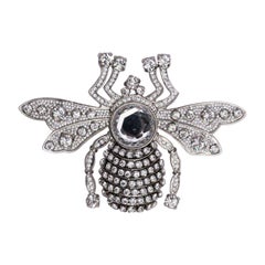 Broche Nina Ricci de metal dorado con strass multicolor