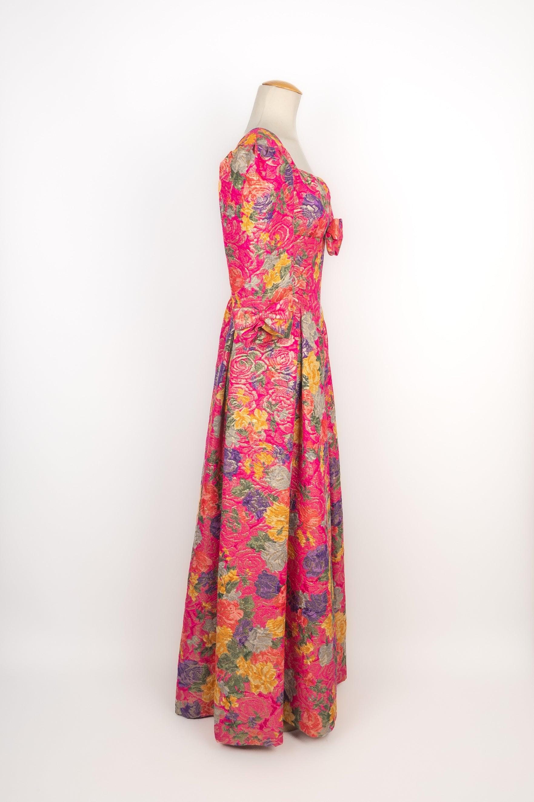Nina Ricci - Long jacquard dress with flower patterns in pink, yellow, and purple tones. No size indicated, it fits a 36FR. A Haute Couture Collection Automne-Hiver 1991. 

Additional information:
Condition: Very good condition
Dimensions: Shoulder