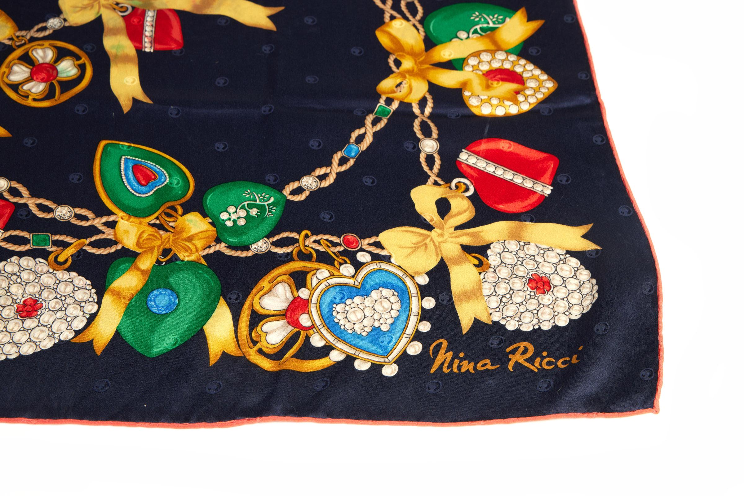 Nina Ricci navy blue silk scarf with jewel charms design. Hand rolled edges.
