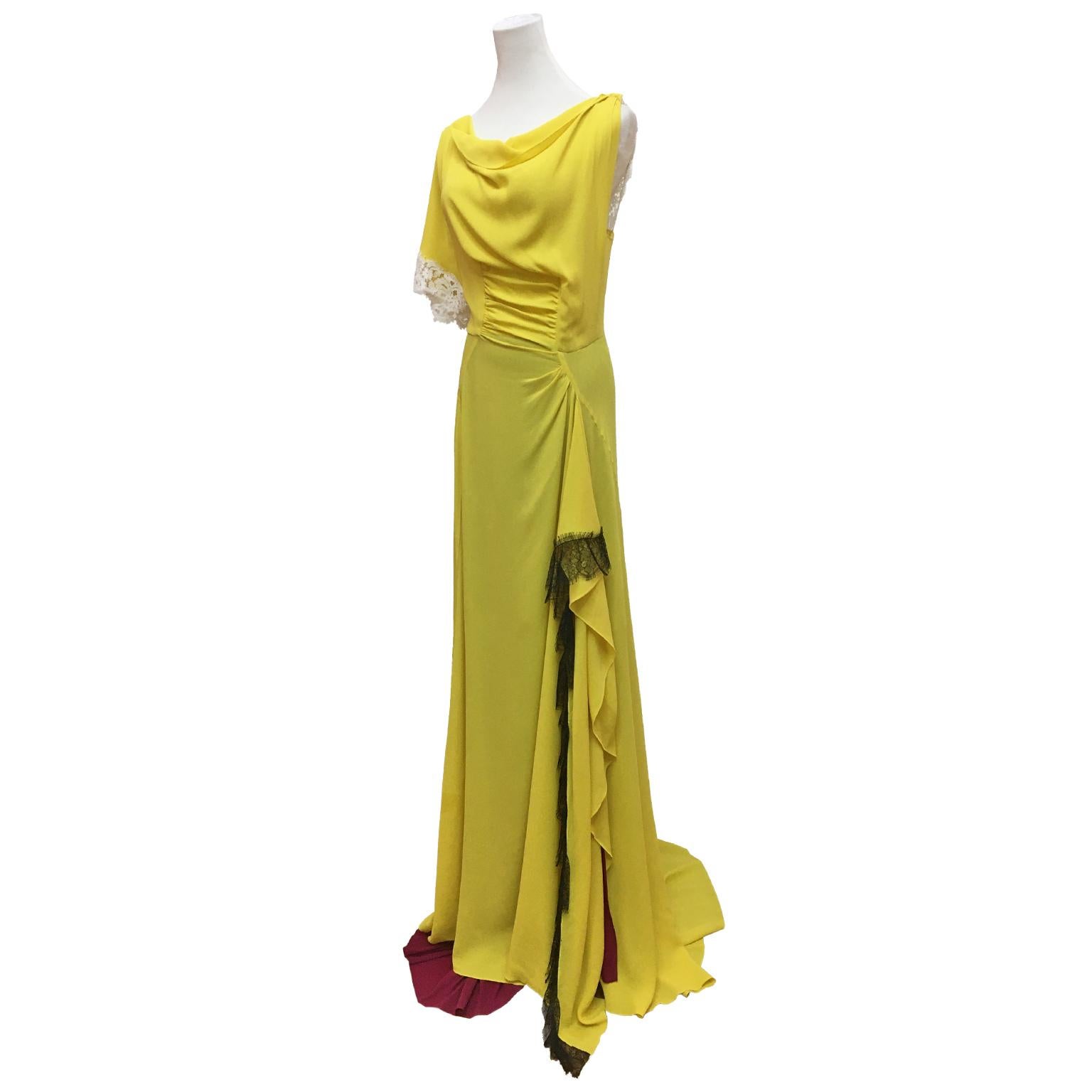 This is an outstanding silk gown sample from Olivier Theyskens for Nina Ricci circa 2010. This full length and train asymmetric dress has dramatic statement with contrasted lining in Bordeaux with Theyskens signature yellow -  with black lace trim.