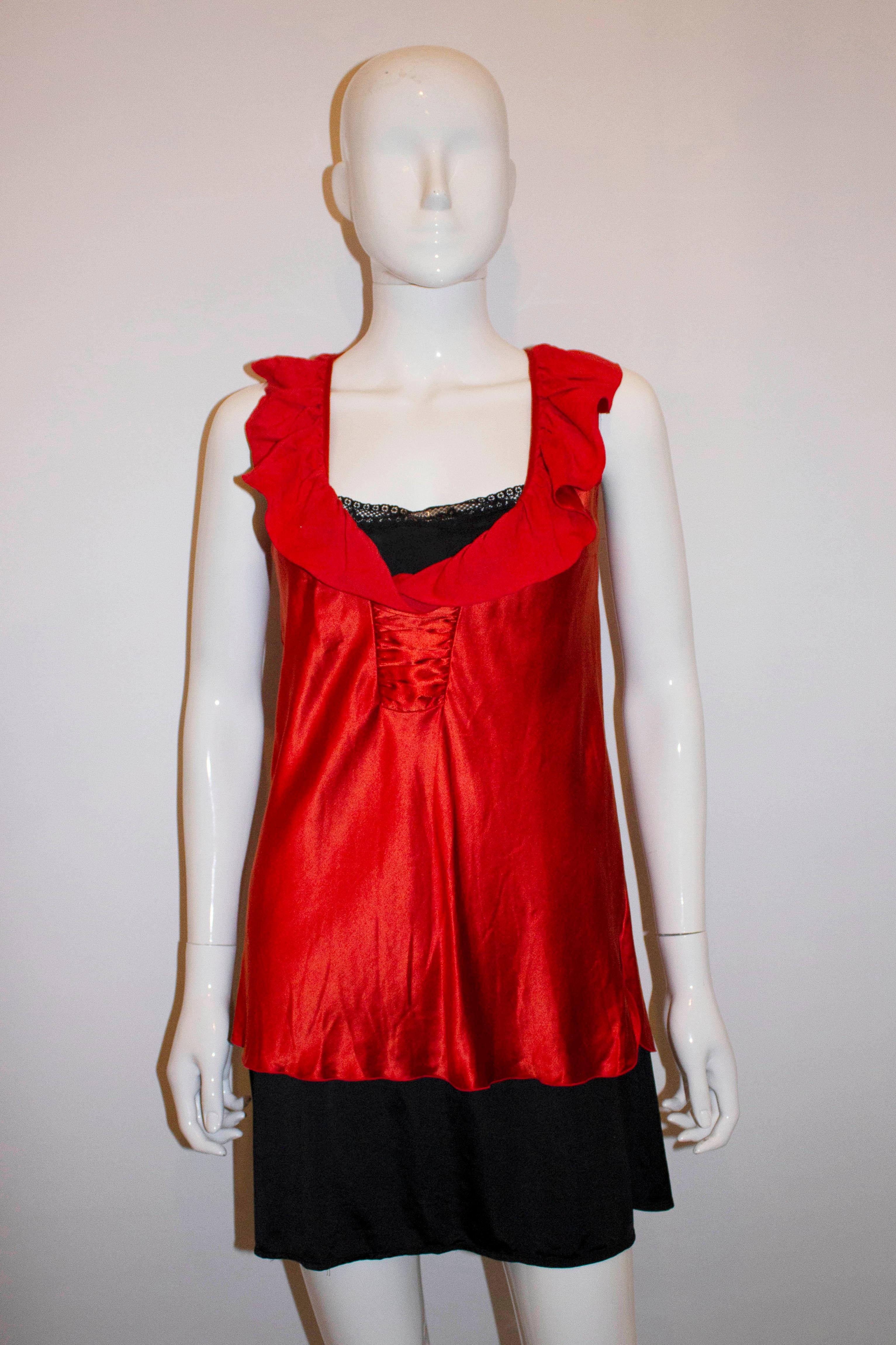 A pretty top for Summer by Nina Ricci , Paris. The top is in a silk mix with a v neckline, with ruffle detail and pleats at the front. It has 5'' slits on either side.  Size Eu38, Italian 42 Bust 38'', length 27''