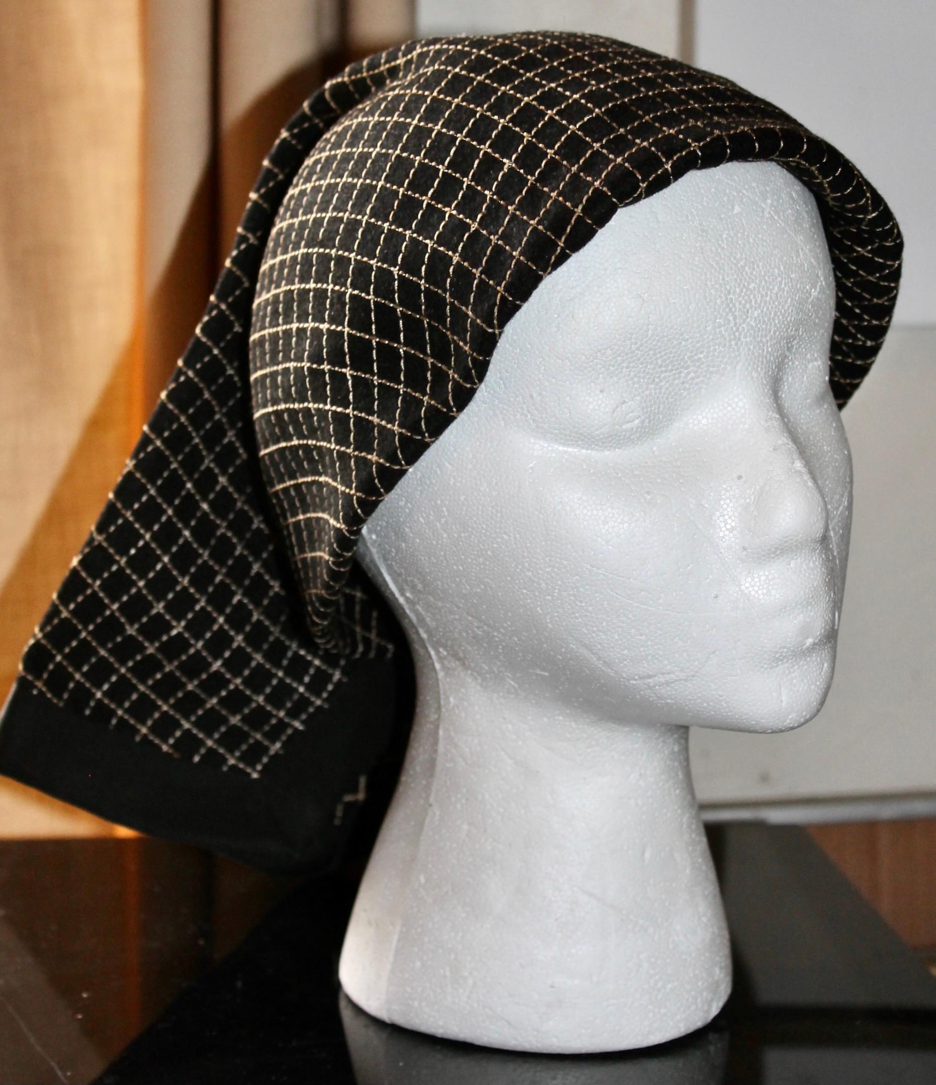 Consisting of black felt, gridded with gold thread, folded into a 'Peasant'
scarf form.