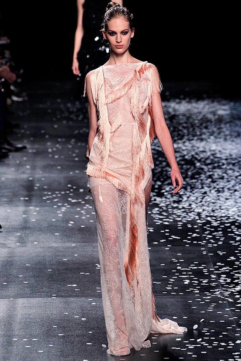A rare Nina Ricci creation from the romantic Spring 2013 runway collection.  Featuring  romantic couture touches combined with a lighthearted spirit.  Peachy pink colorway boasts swags of decorative silk fringe arranged asymmetrically onto delicate