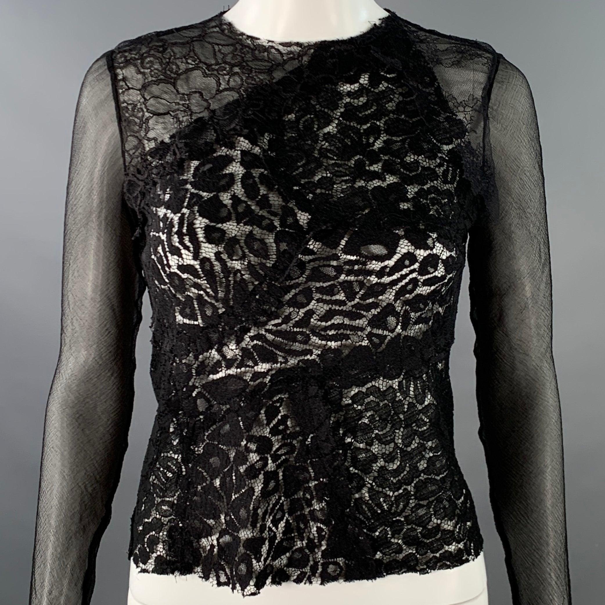 NINA RICCI robe top
en dentelle noire, manches longues, bords bruts et fermeture à glissière dans le dos.Excellent état d'occasion. 

Marqué :   taille non marquée, pas d'étiquette. 

Mesures : 
 
Épaule : 12.5 inches Buste : 32 inches Manches : 26