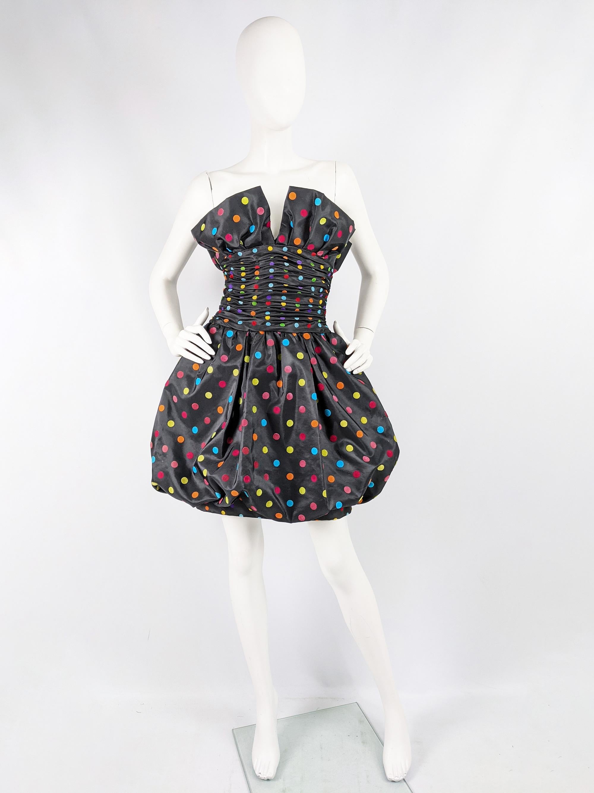A fabulous vintage womens vintage womens evening dress from the 80s by luxury fashion designer, Nina Ricci. In a black taffeta with multicoloured flocket velvet polka dots throughout and a puffball skirt. 

Size: Not indicated; fits like a modern