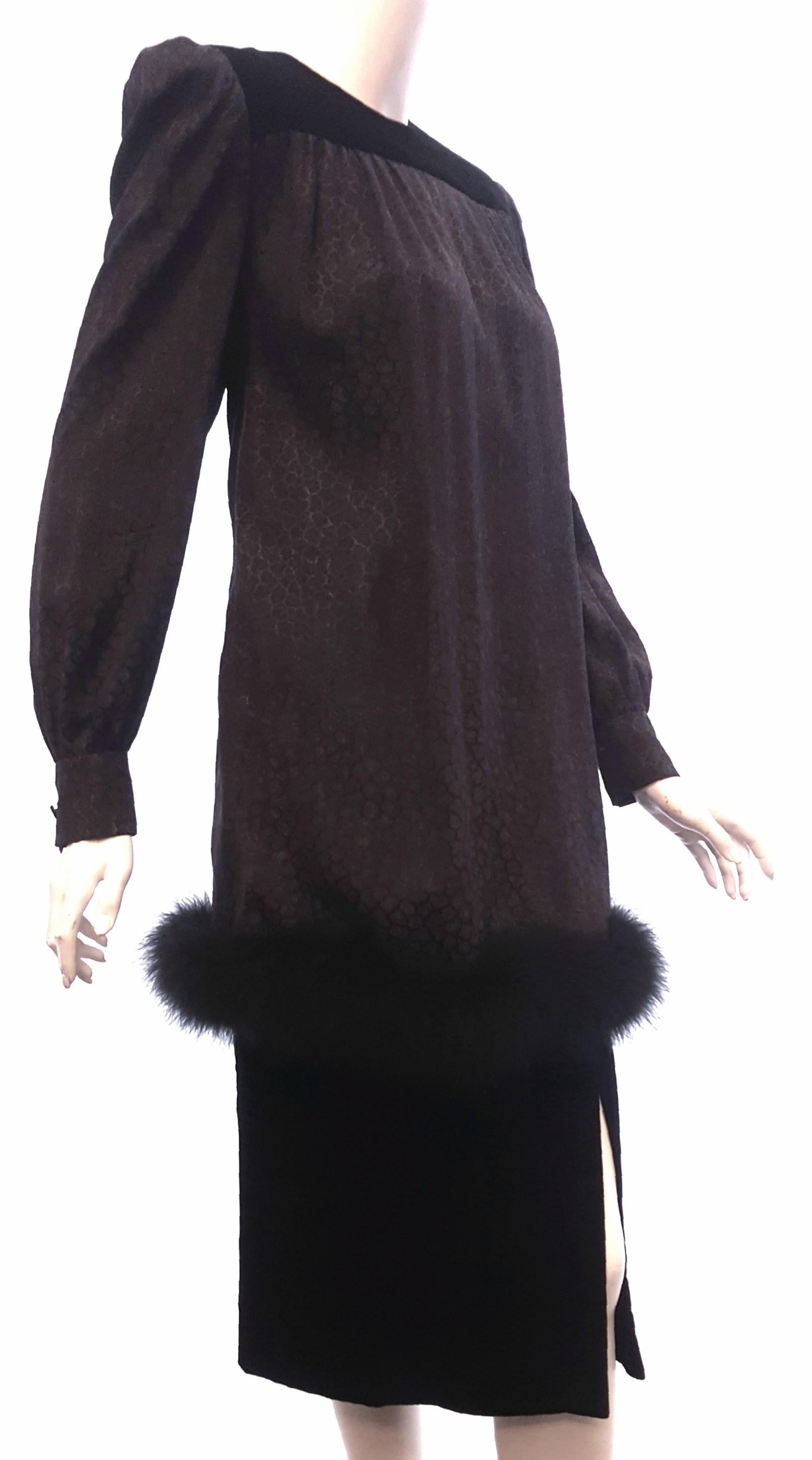 This long sleeve silk vintage dress top with feather trim around the hem also includes a velvet skirt.  The velvet skirt has a side opening slit and is lined.  The top is not lined and has a zipper at the back for closure and buttoned cuffs.  The