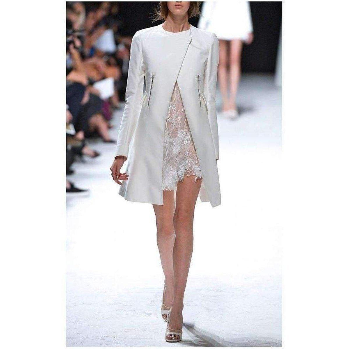 Lined with silk for a luxurious feel, nina ricci's cotton-blend lace dress is a fantasy of a frock. 
The snow-white colour, flocks of texture at the hem and a-line silhouette make it inimitably feminine. 
Button at the nape of the neck. 
Fully