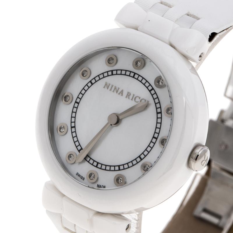 This Nina Ricci watch is a perfect addition to your watch collection- thanks to its modish yet classic silhouette. It features a white ceramic body with a rounded mother of pearl dial. The dial comes with diamond markers and silver-tone hands. It