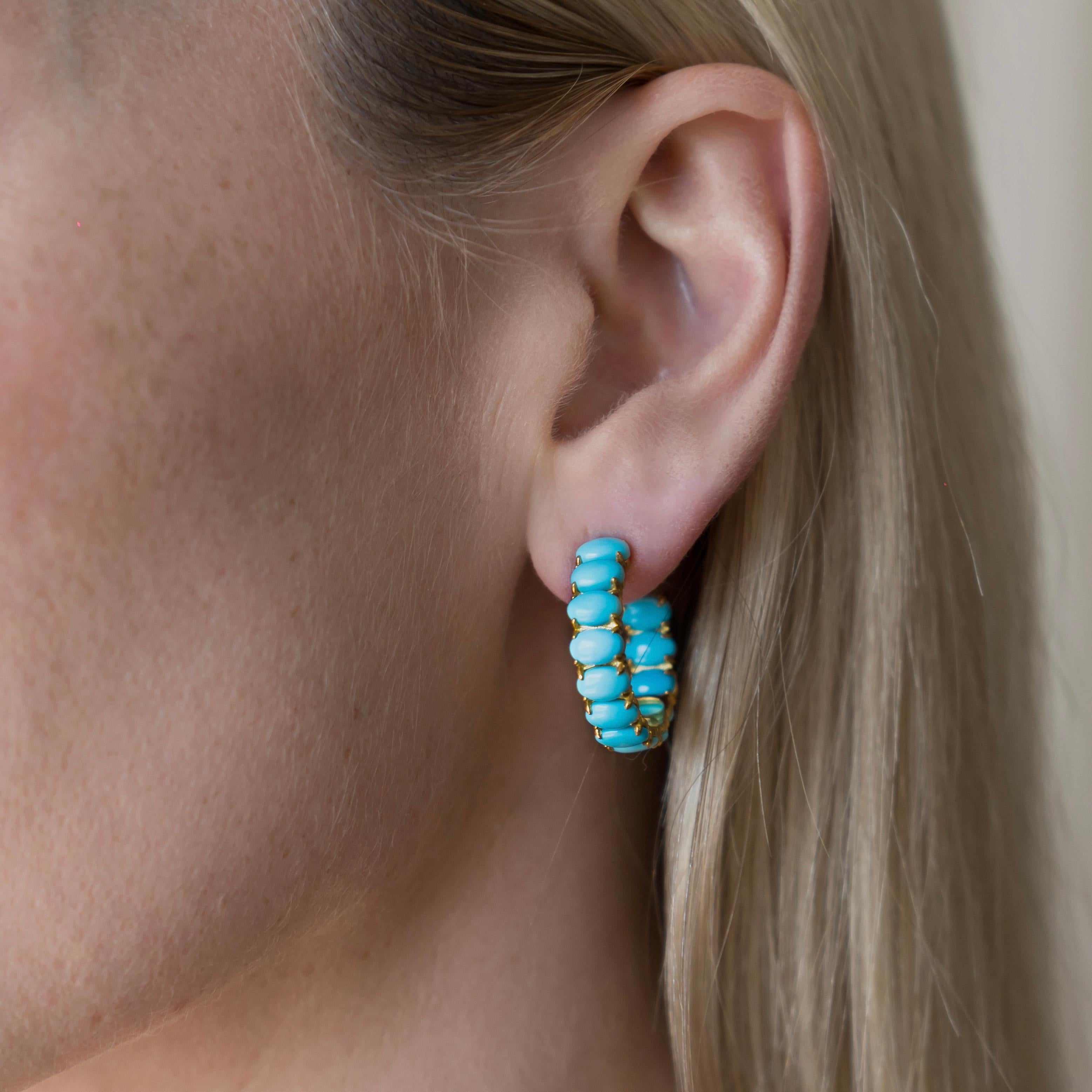 Nina Zhou's 10ct Turquoise Inside-out Hoop Earrings in 14k yellow gold encapsulate vibrant elegance with a modern twist. Crafted meticulously, these stunning hoops showcase richly hued, 10-carat turquoise gemstones set both inside and outside,
