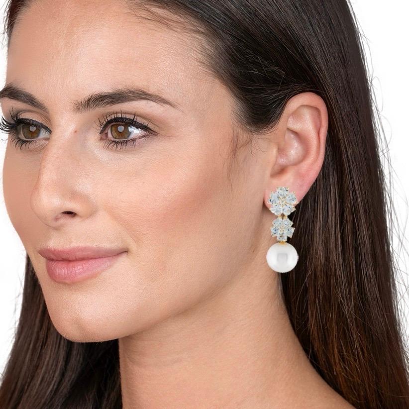 Discover Nina Zhou Aquamarine Diamond Blossom 12-13mm Pearl Convertible Drop Earrings in 14k Yellow Gold. These earrings blend the serene glow of aquamarine with the timeless sparkle of diamonds, all cradled in a delicate, nature-inspired blossom