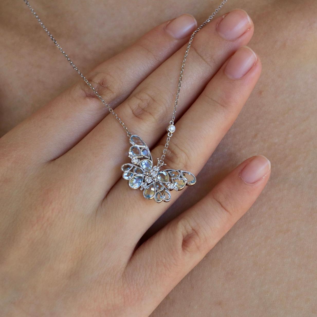 Take flight into elegance with this 2.50ctw Aquamarine Diamond Butterfly Pendant Necklace, a masterpiece that captures the lightness and beauty of nature. Set in 14K white gold, the delicate butterfly design shimmers with soft aquamarine stones,