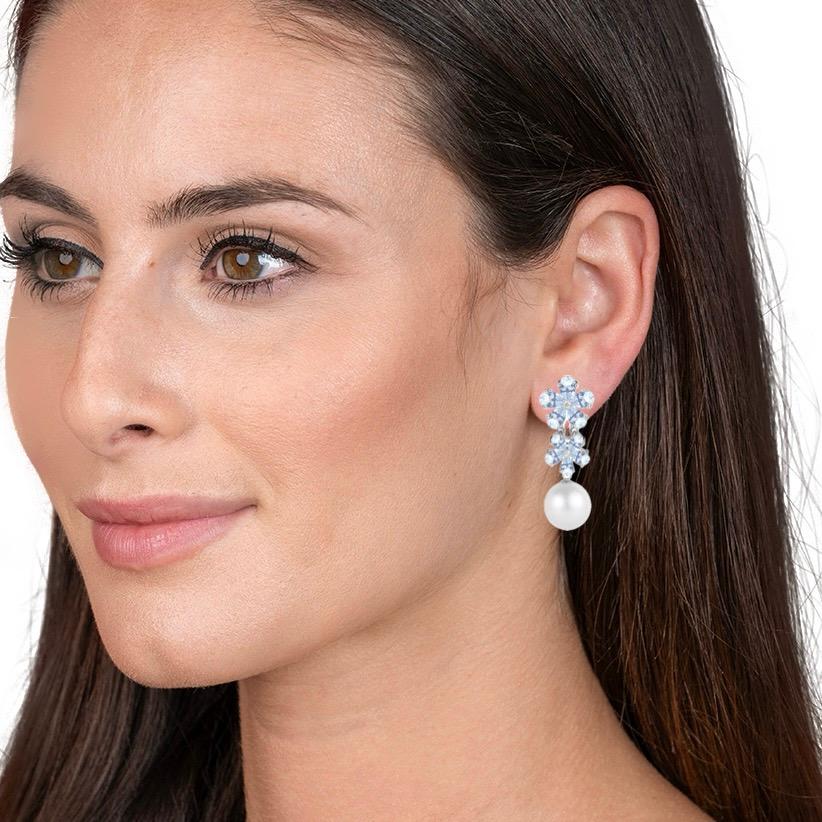 Discover the Nina Zhou Aquamarine Diamond Blossom and 12-13mm Pearl Convertible Drop Earrings in 14K White Gold. The soft blue of aquamarine pairs beautifully with the shining of diamonds in a floral-inspired design. The earrings are designed with