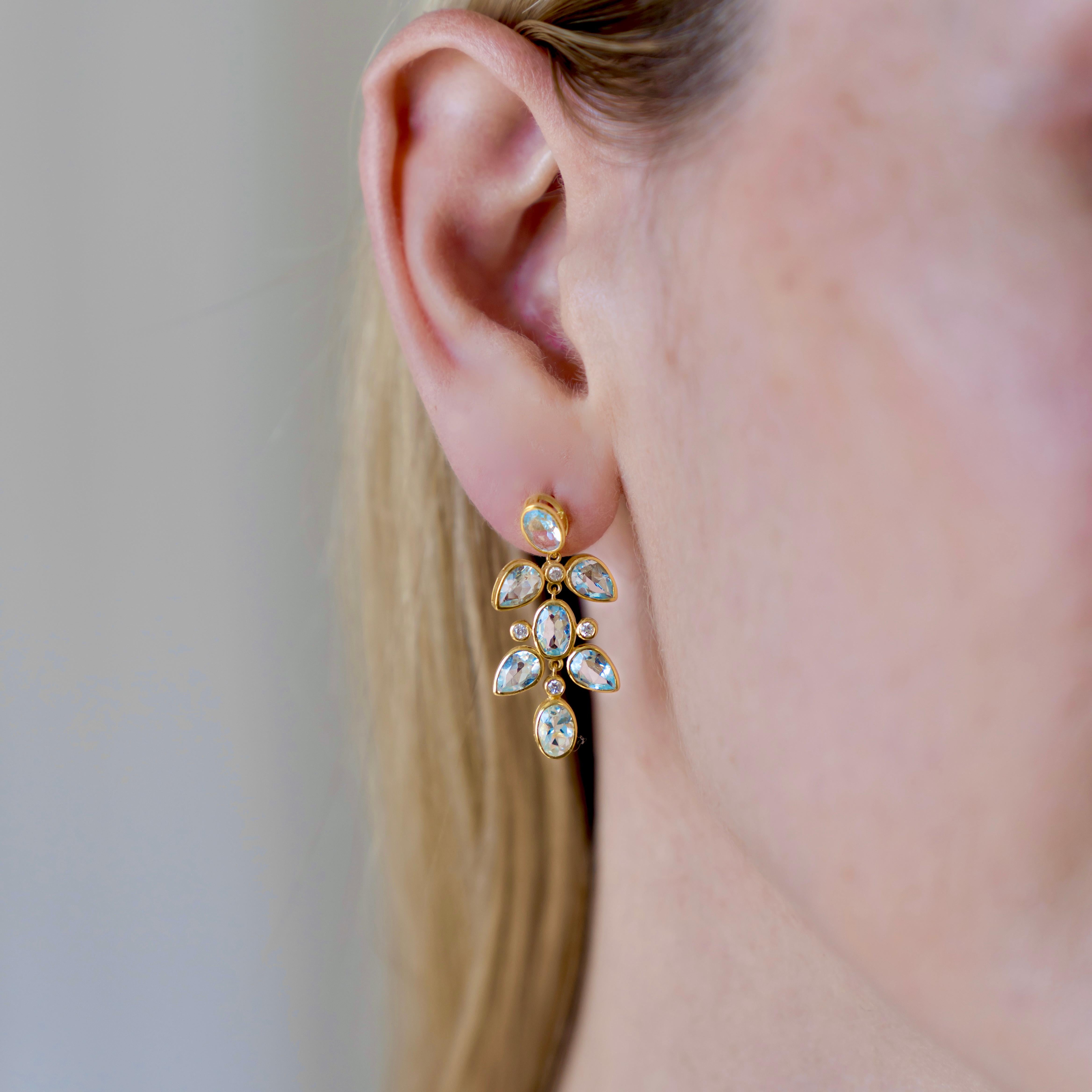 Nina Zhou's Aquamarine Diamond Drop Earrings, beautifully crafted in 14k yellow gold. Each earring showcases stunning aquamarine gemstones, revered for the clear, oceanic blue that evokes a sense of calm and clarity. These captivating stones are