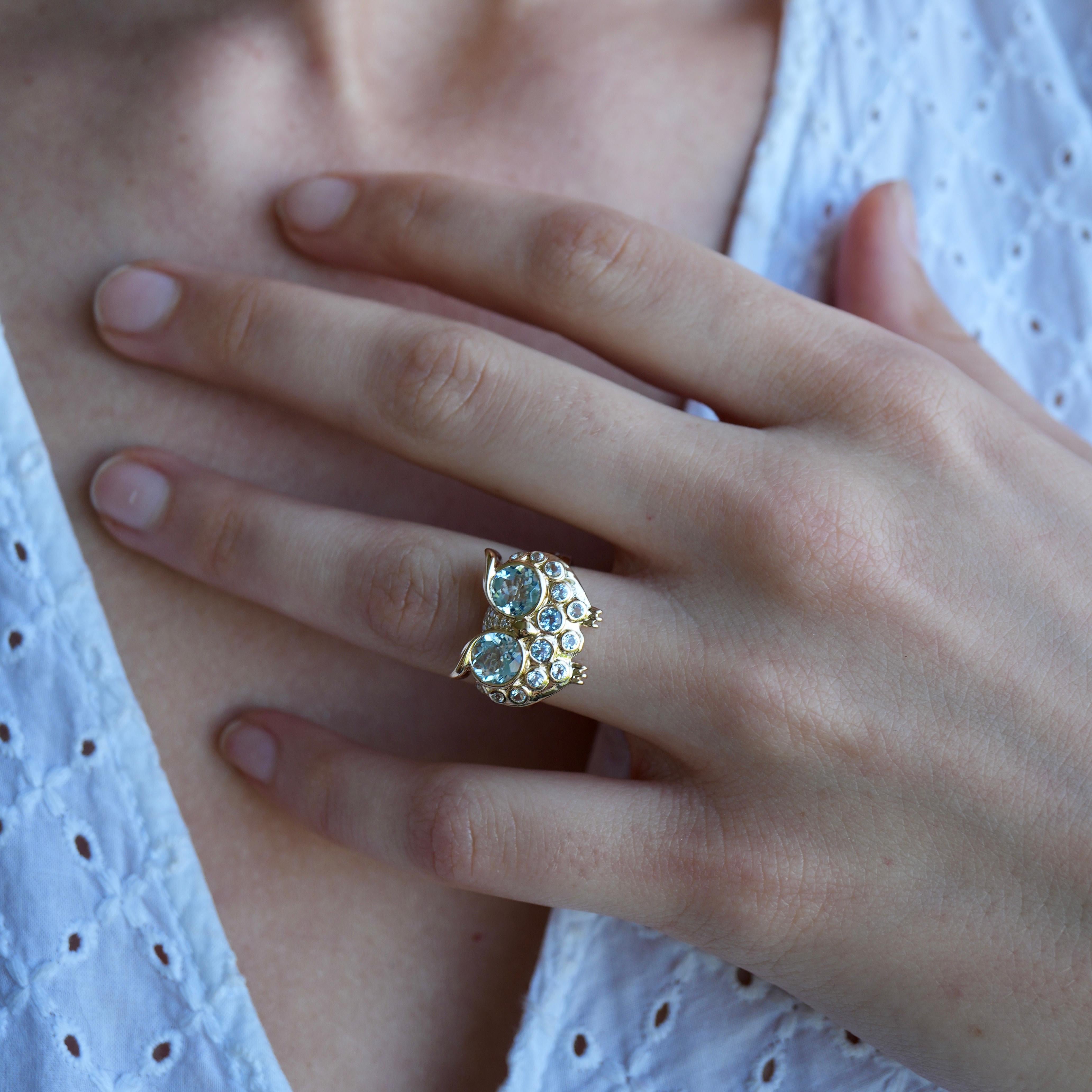 A playful fusion of whimsy and craftsmanship, this Nina Zhou Owl Ring is sculpted in luminous 14K yellow gold and set with a captivating arrangement of natural aquamarines and diamonds. The twin round-cut stones form the owl’s wide-eyed gaze,