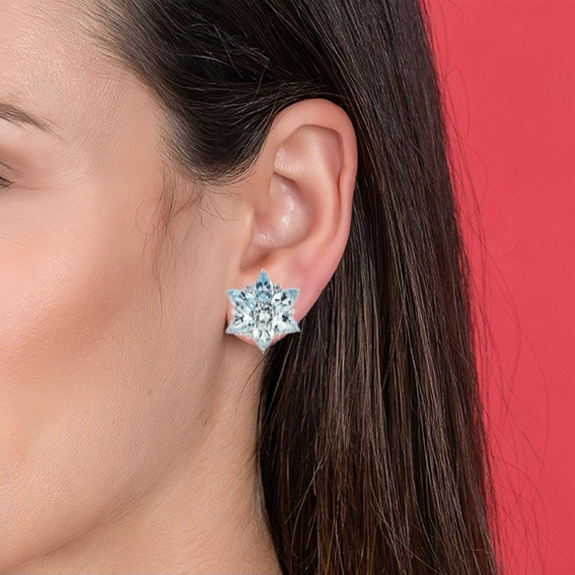 Discover Nina Zhou 4.80ct Aquamarine and 0.18ct Diamond Snowflake Earrings in 14k White Gold. These earrings are a celebration of the season's magic, capturing the essence of glistening snowflakes in a mesmerizing design. Each earring features a