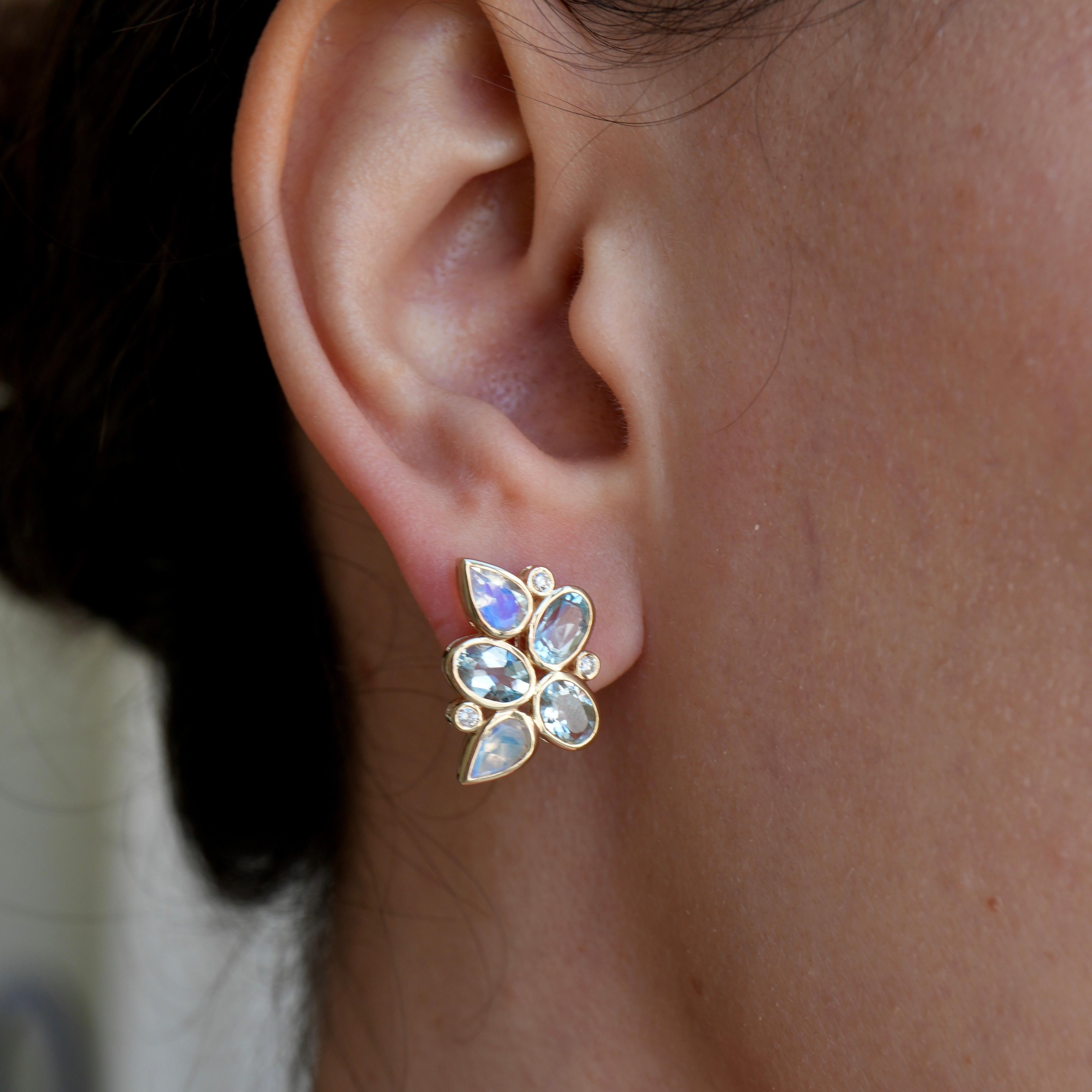 Discover the ethereal beauty of Nina Zhou's Aquamarine Moonstone Diamond Earrings, where the magic of the moon and the depth of the ocean unite in a symphony of elegance. 

Crafted in radiant 14k yellow gold, these earrings are a testament to