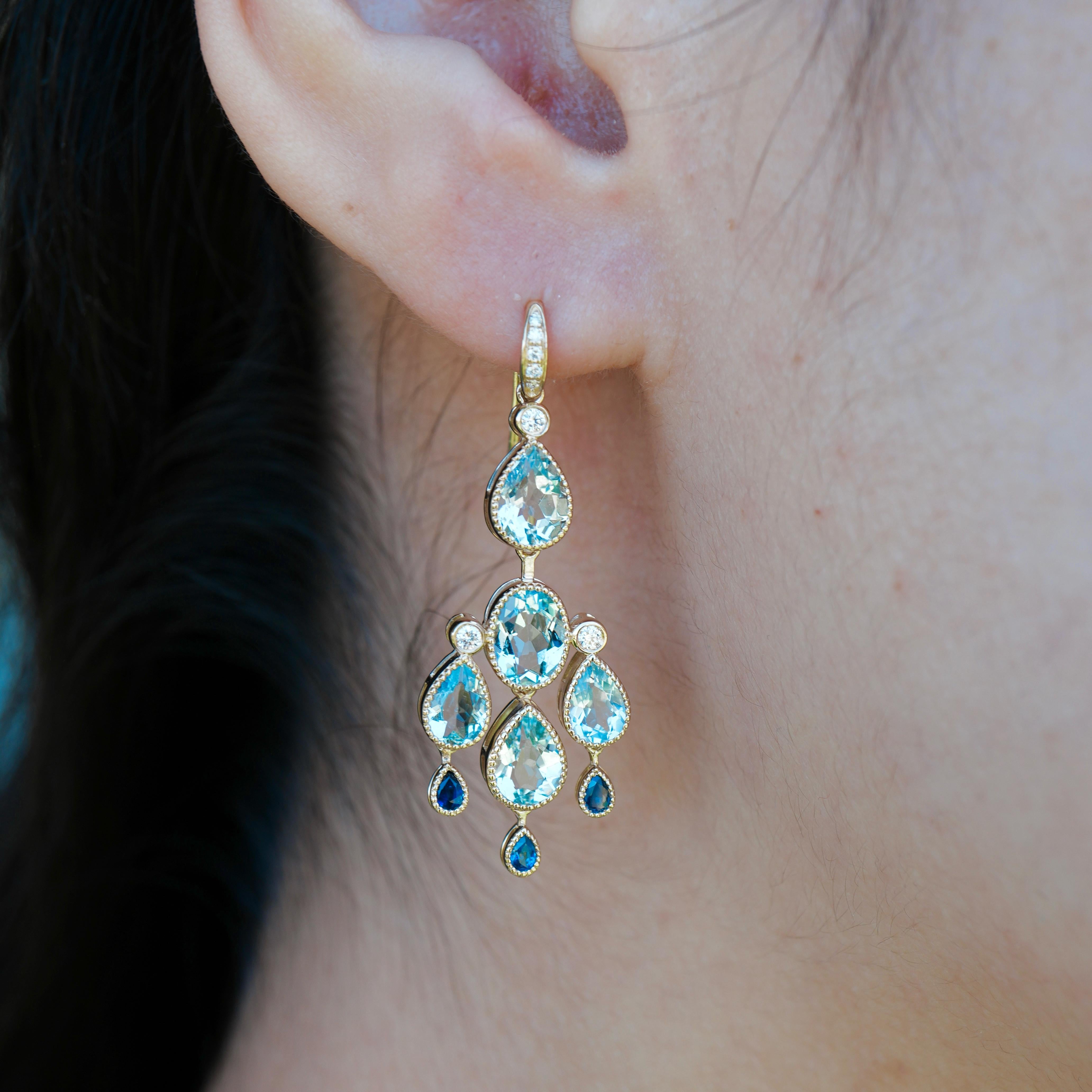 Cascading in refined brilliance, these chandelier earrings feature a radiant blend of pear-shaped aquamarines, glittering diamonds, and deep blue sapphires—each stone carefully set in 14k yellow gold to capture light with every movement.

Balancing