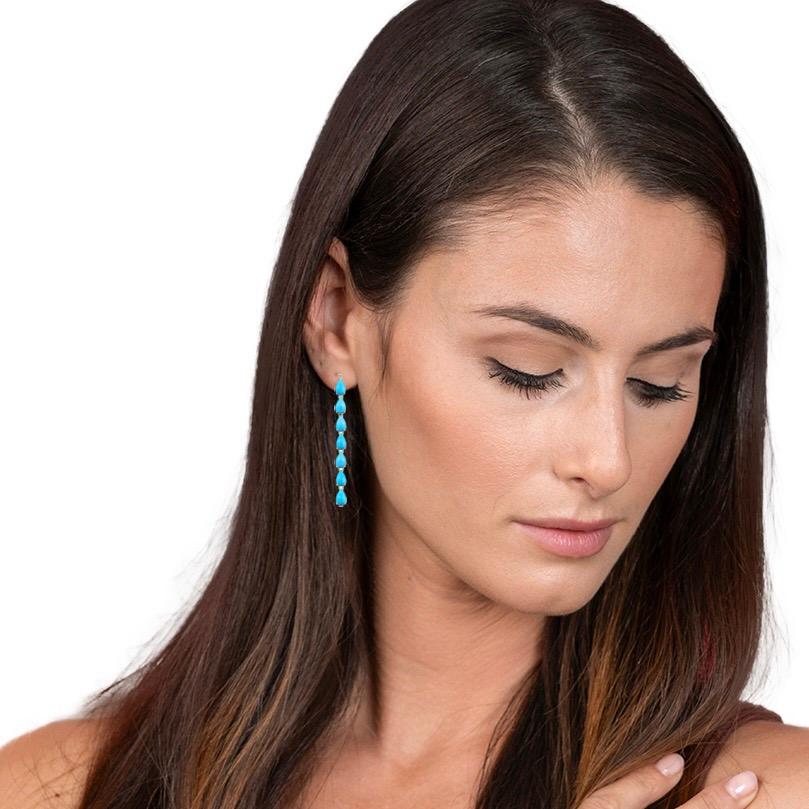 Nina Zhou's Blue Turquoise Diamond Line Drop Earrings, crafted in luxurious 18k yellow gold, offer a breathtaking display of elegance and style. These earrings feature striking blue turquoise stones, known for their vivid, oceanic hues that convey