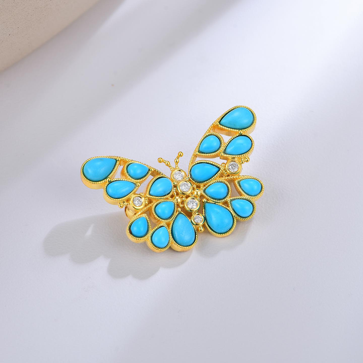 Embrace the beauty of transformation with the Nina Zhou Butterfly Turquoise Diamond Brooch in Yellow Gold. This exquisite brooch showcases a stunning butterfly design, adorned with vibrant turquoise stones that capture the eye with their serene blue