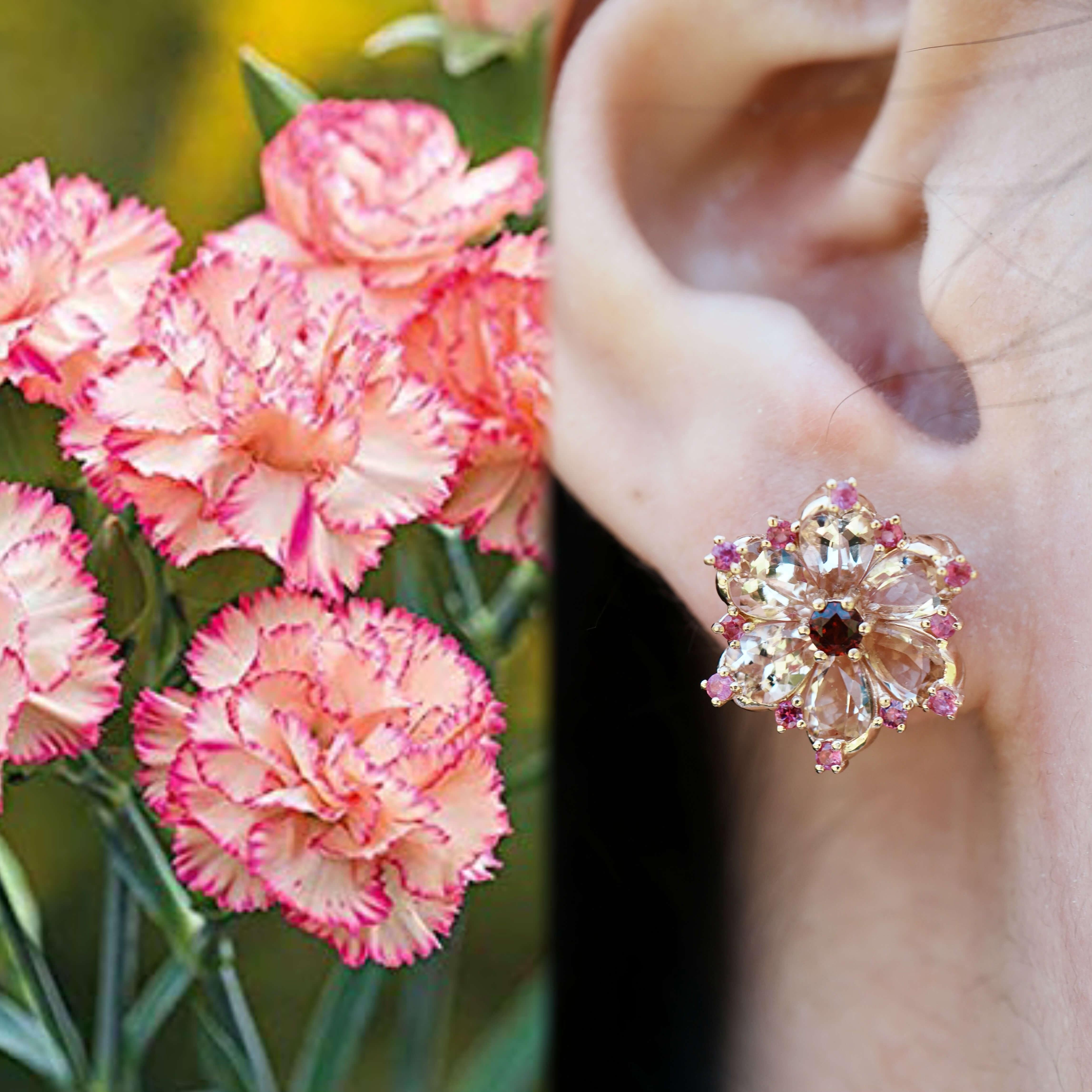 These striking earrings reinterpret the carnation—the birth flower of January—with a radiant composition of morganite, pink sapphire, and rhodolite garnet. The layered petal design evokes the depth and fullness of real carnations, while the rich
