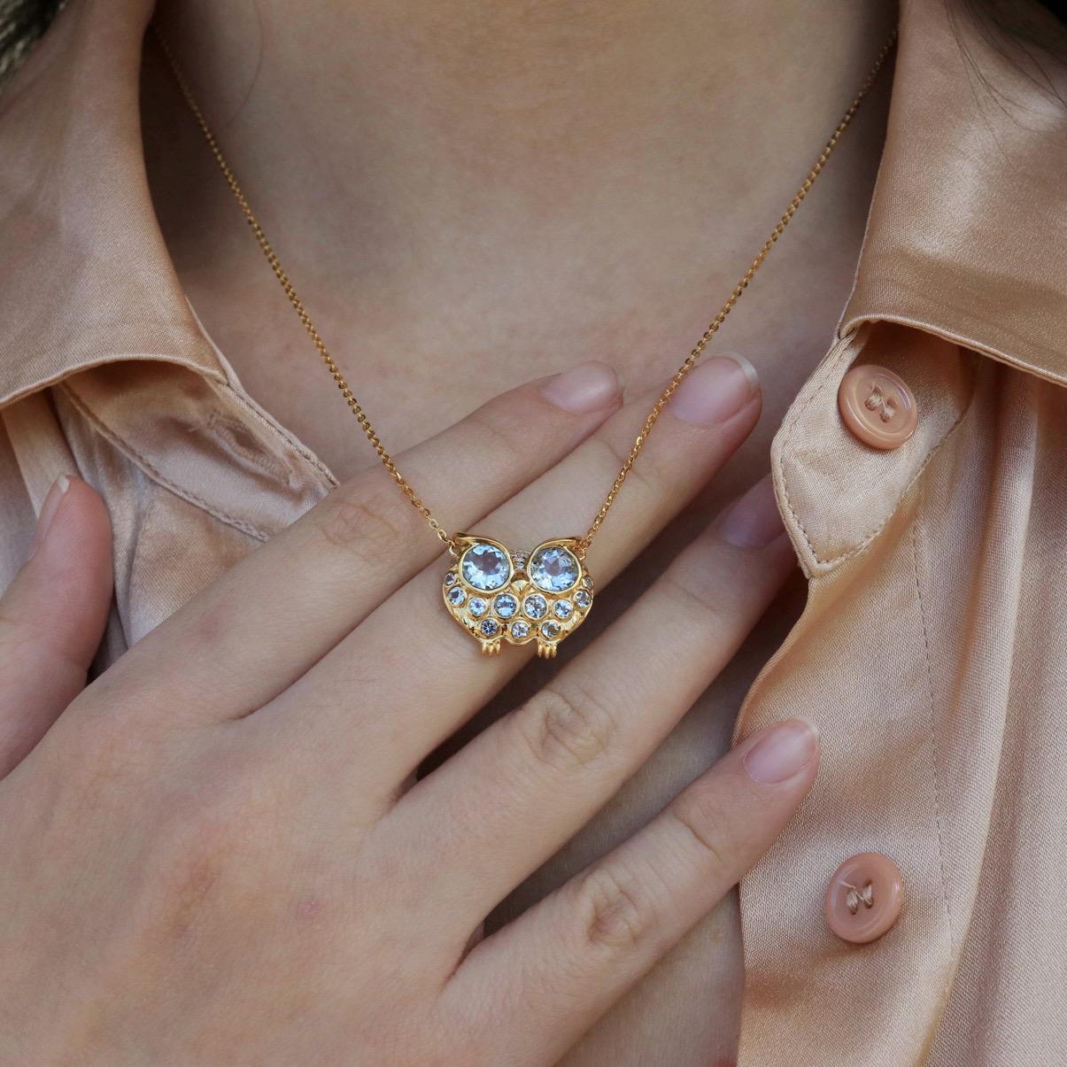 Channeling the symbolic wisdom and mystery of the owl, this enchanting pendant showcases an elegant fusion of artistry and gemstones. Gleaming aquamarine gemstones, known for their calming sky-blue hues, form the captivating eyes and delicate