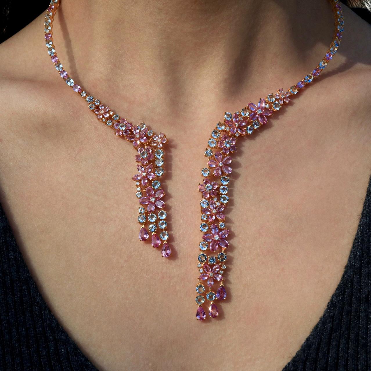 Enter a world of celestial elegance with the Galaxy Aquamarine Pink Sapphire Diamond Statement Necklace. This piece features an array of aquamarine and pink sapphires, arranged to create a stunning cascade of color. With a total carat weight of 28ct