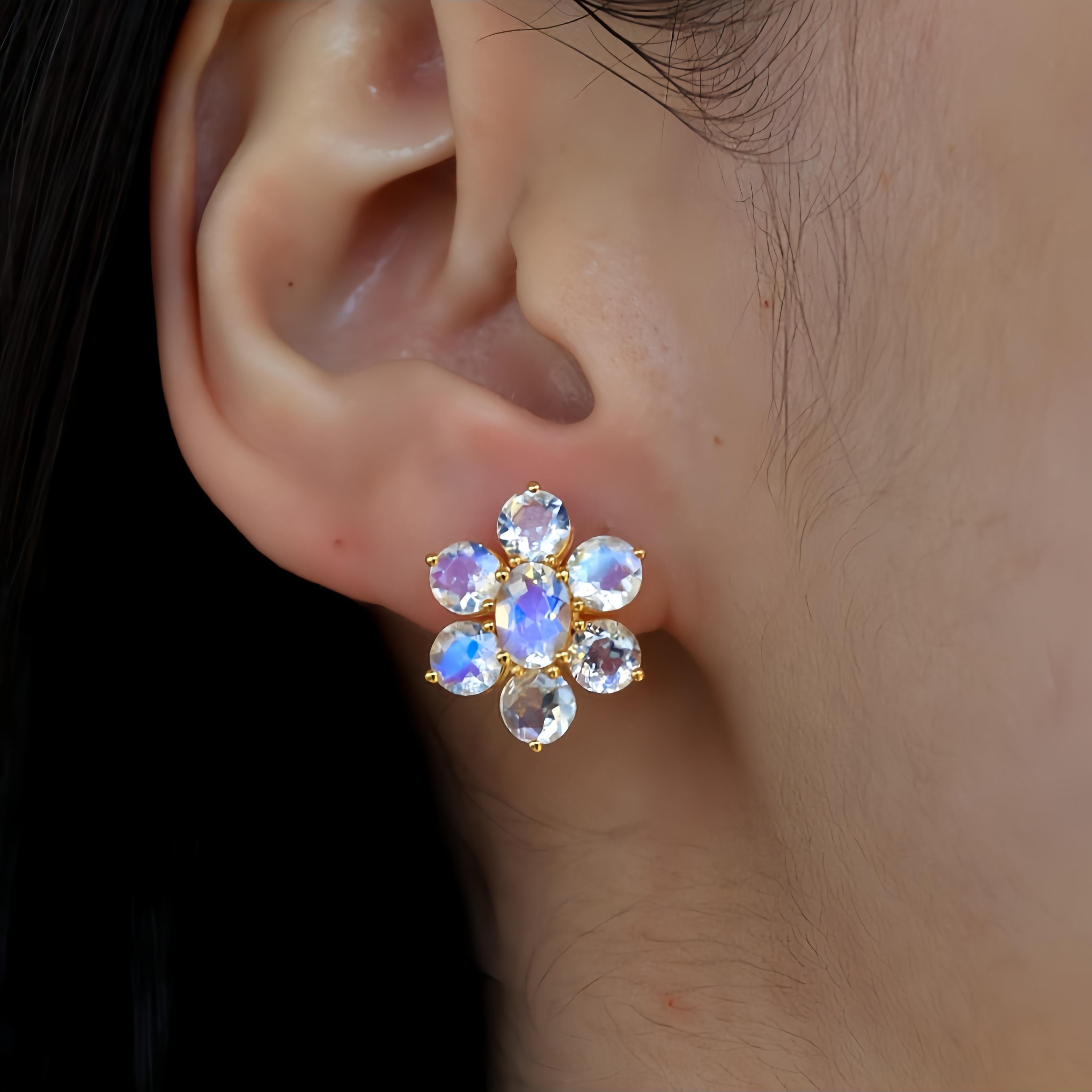 Nina Zhou's Moonstone Cluster Earrings, masterfully crafted in sumptuous 14k yellow gold. Each earring was made with magnificent moonstone, celebrated for its vibrant,  blue hue that captures the essence of the Moon. 

Surrounding the central gem
