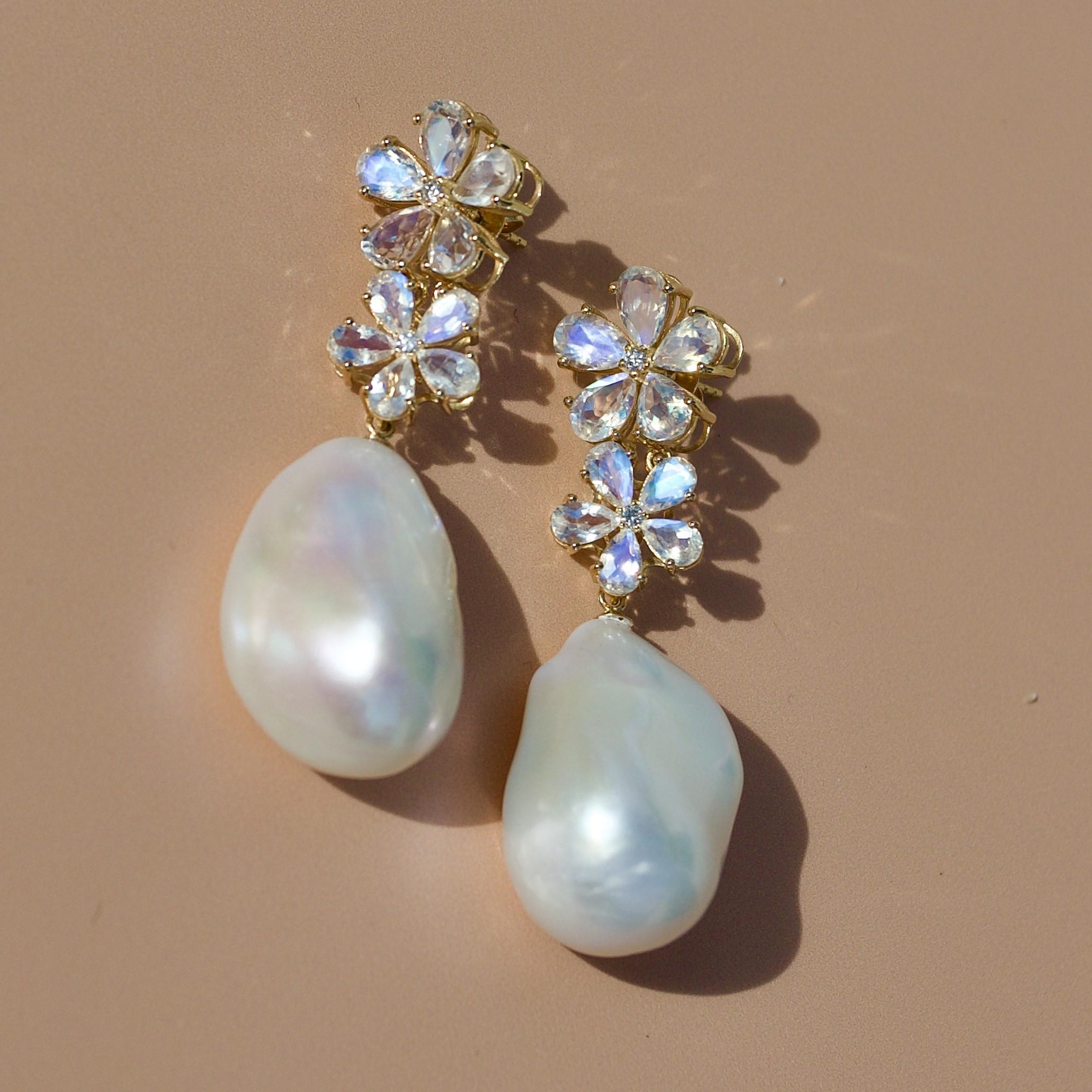 Discover Nina Zhou Moonstone Diamond Blossom and Baroque Pearl Convertible Drop Earrings in 18k Yellow Gold. These earrings blend the serene glow of moonstones with the timeless sparkle of diamonds, all cradled in a delicate, nature-inspired blossom