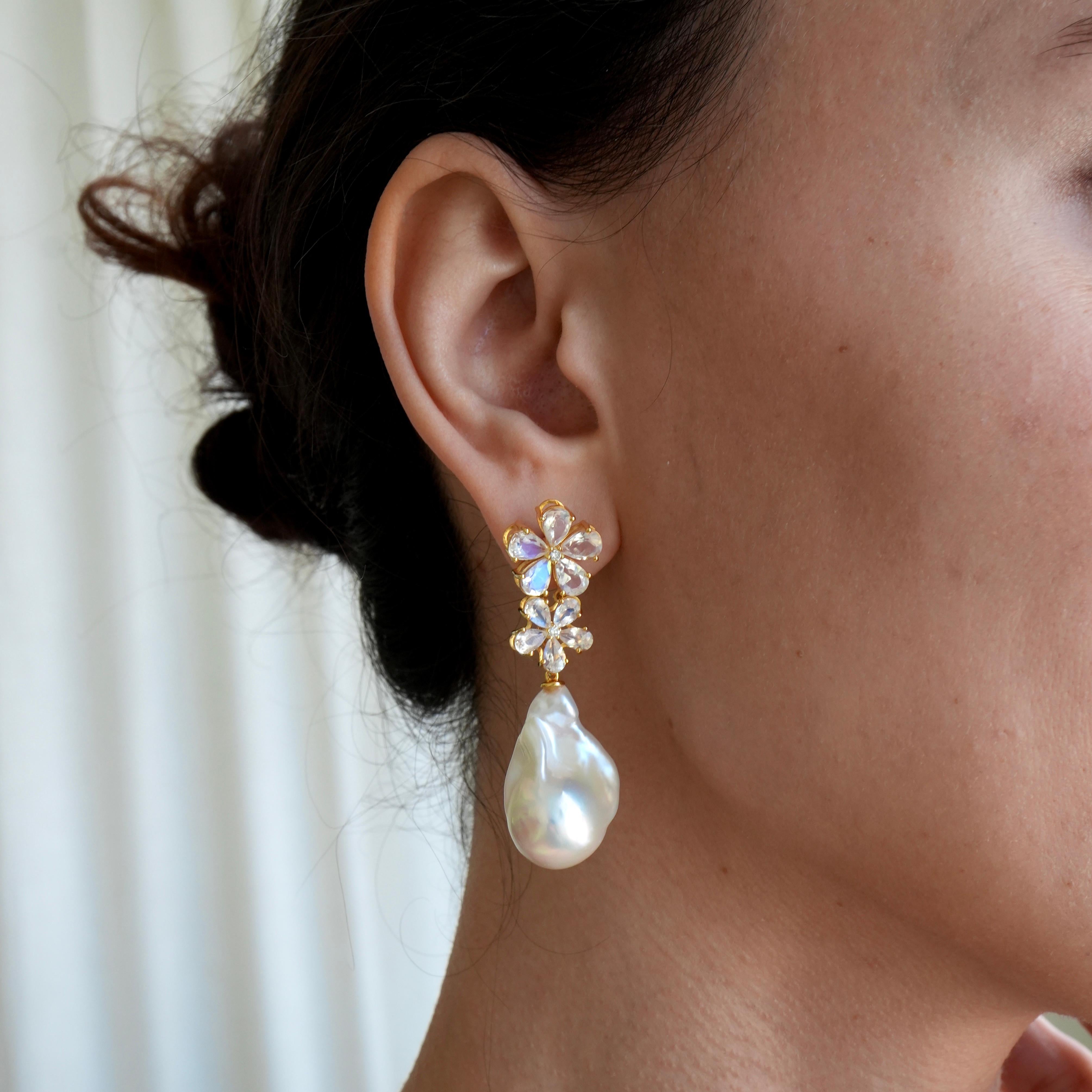 Discover Nina Zhou Moonstone Diamond Blossom and Baroque Pearl Convertible Drop Earrings in 14k Yellow Gold. These earrings blend the serene glow of moonstones with the timeless sparkle of diamonds, all cradled in a delicate, nature-inspired blossom