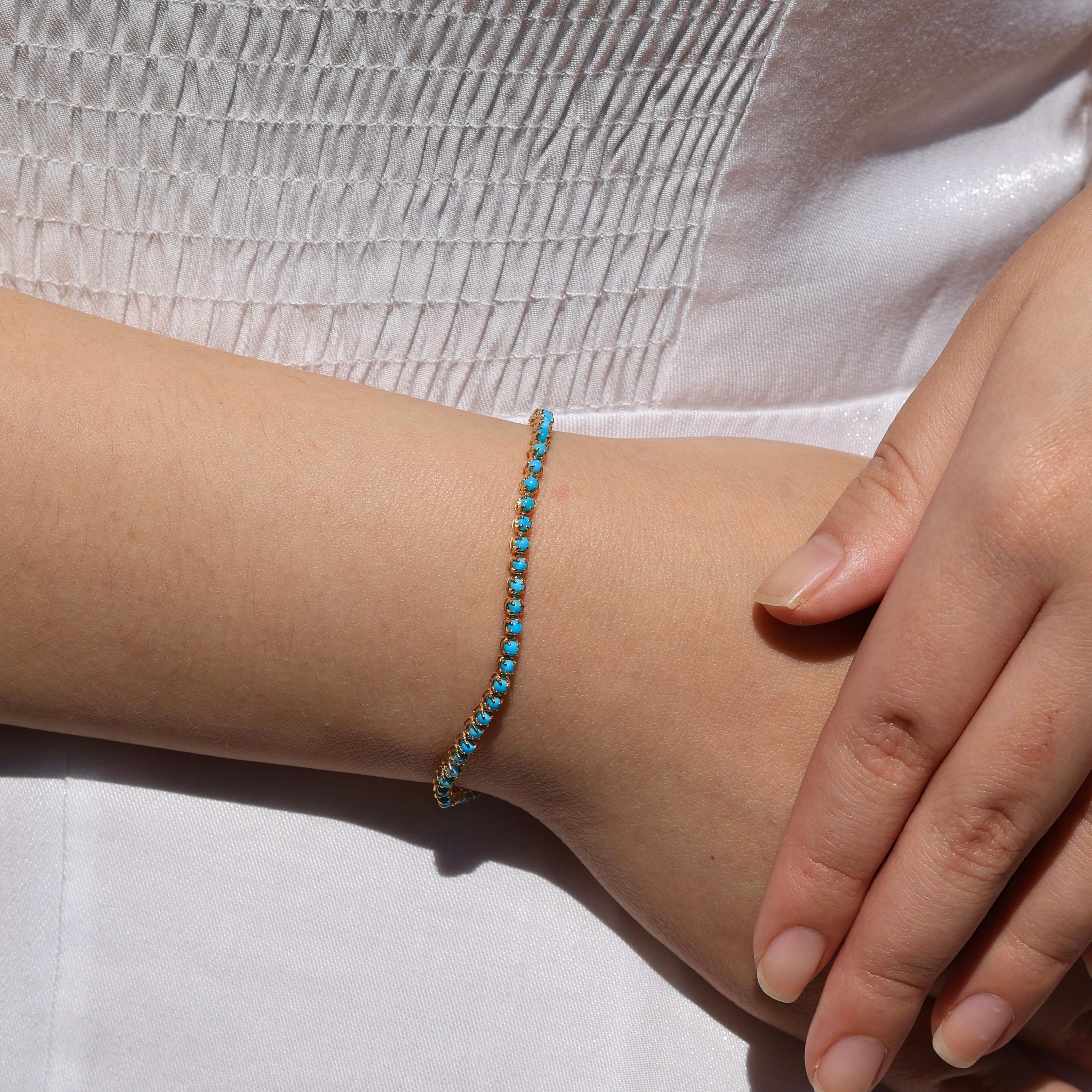 The stunning Turquoise Tennis Bracelet features a radiant row of eye-clean, round-cut turquoise gemstones, offering a perfect balance of color. Set in yellow gold, the turquoise stones’ vivid blue hue brings a sense of calm and luxury to any