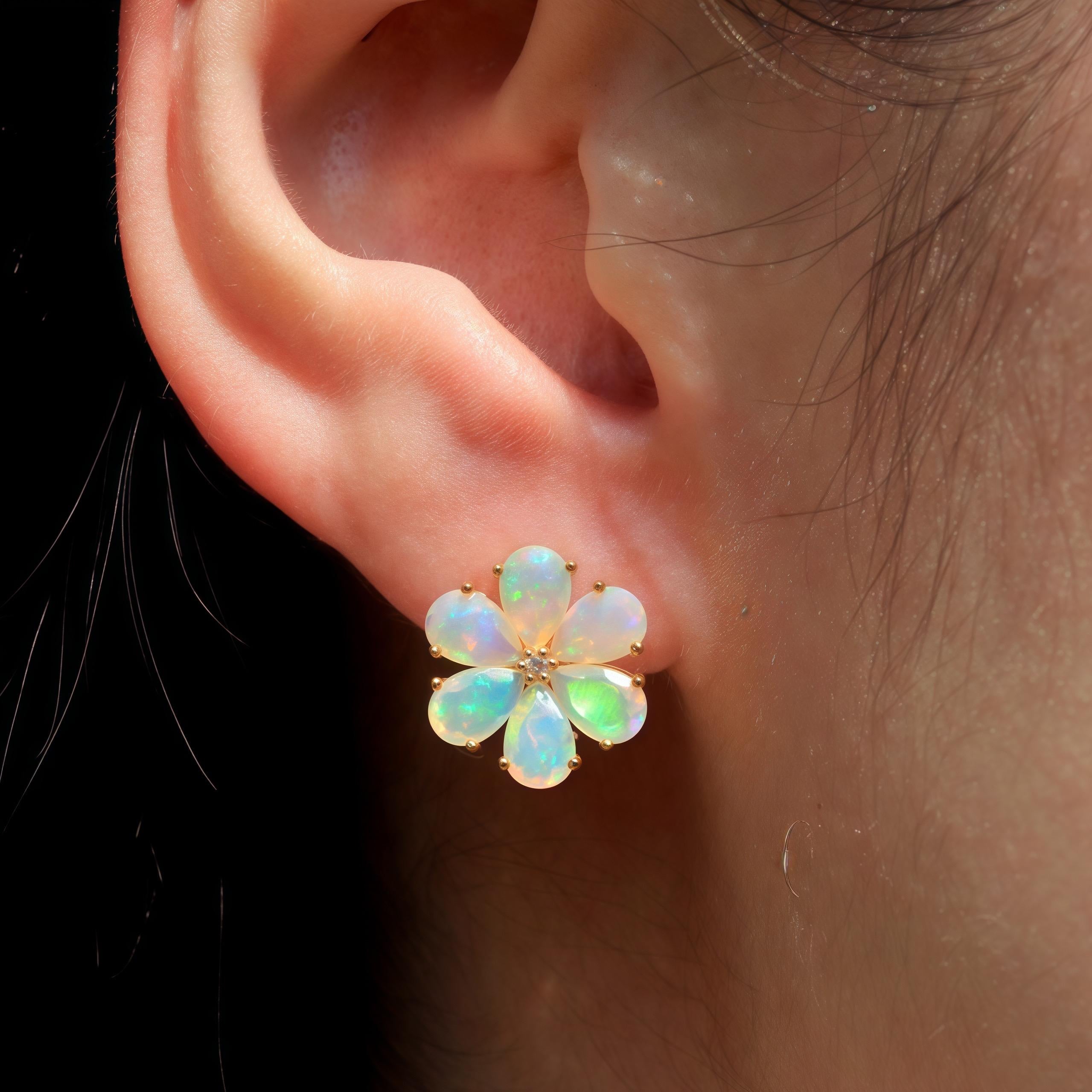 Nina Zhou's Opal Diamond Forget-Me-Not Earrings, exquisitely set in 14k yellow gold. These stunning earrings feature mesmerizing opals, each bursting with an iridescent play of color that captures the imagination. The opals are shaped into the