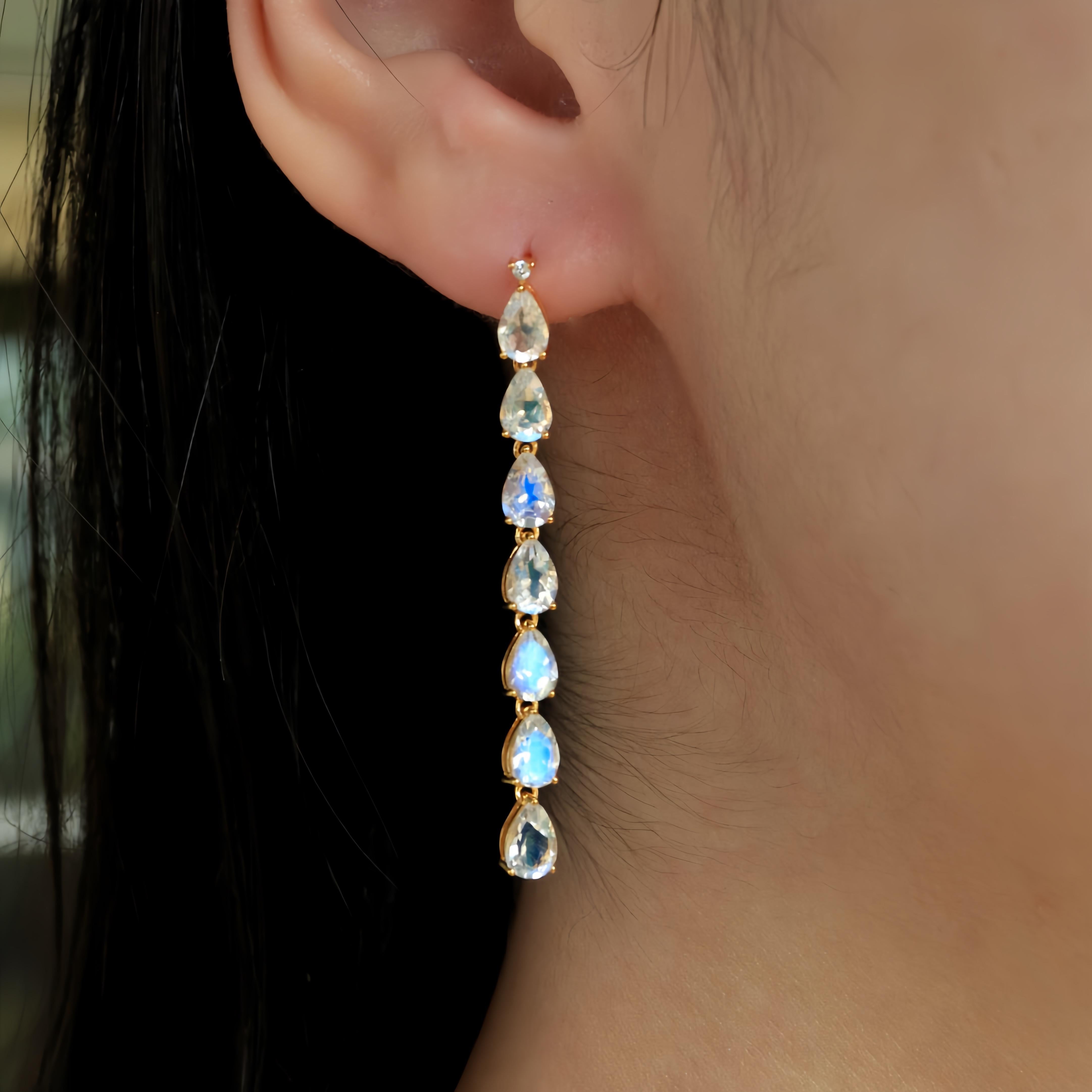 Nina Zhou's Pear Blue Moonstone Diamond Line Drop Earrings in 14k Yellow Gold are a masterpiece of elegance and mystique. Each earring features a mesmerizing pear-shaped blue moonstone, renowned for its captivating luminosity and ethereal blue sheen
