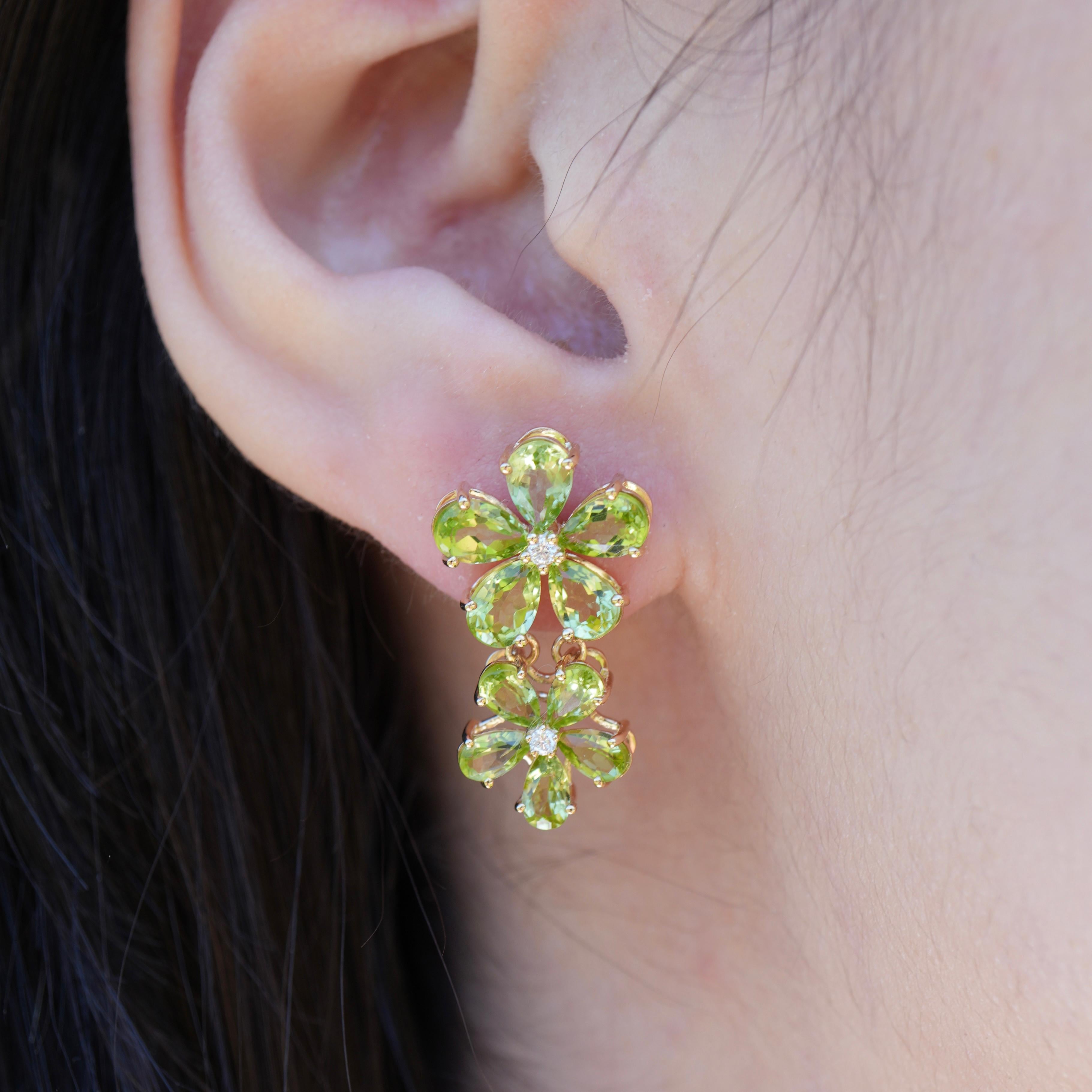 Bursting with radiant green, the Nina Zhou Peridot Diamond Double Blossom Drop Earrings are a celebration of nature’s joyful energy. Each earring features two blooming flower silhouettes, set with vibrant pear-cut peridots that catch the light with