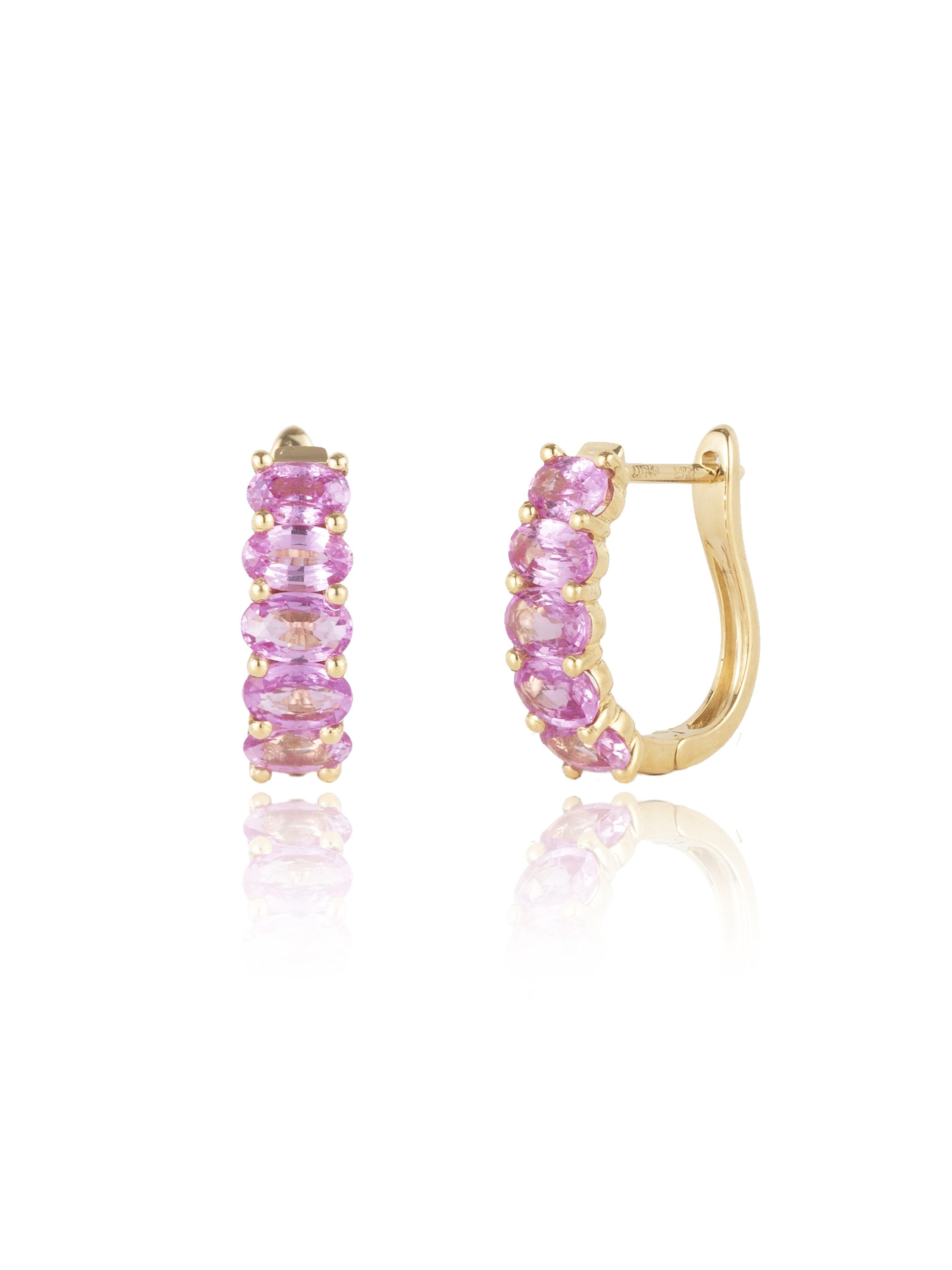 Discover Nina Zhou Pink Sapphire Huggie Earrings with Baroque Pearl Enhancers in 18k Yellow Gold. These earrings blend the serene glow of Pearls with the timeless sparkle of pink sapphire, all cradled in a delicate, classic hoop design. Enhanced by