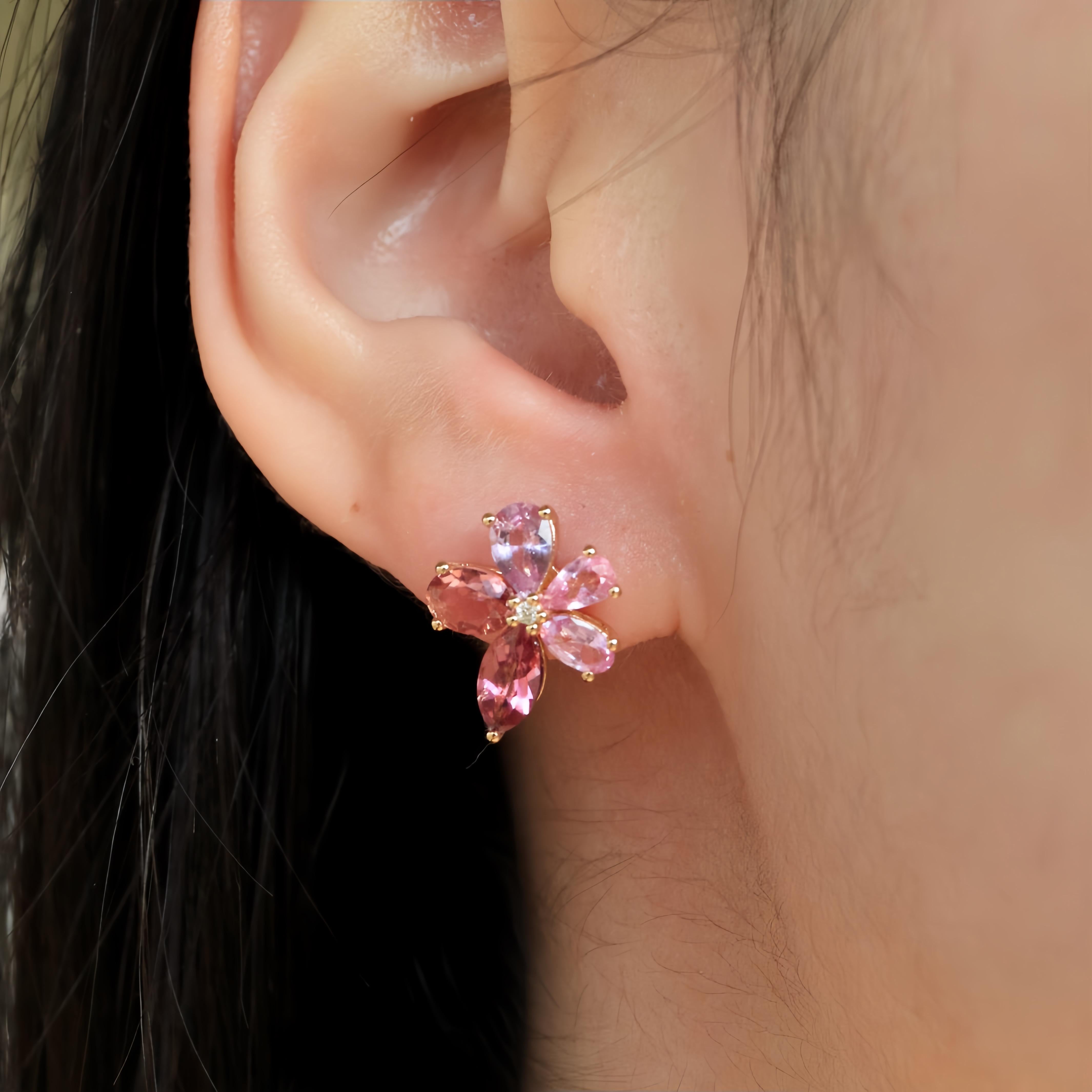 The Pink Sapphire Tourmaline Diamond Blossom Earrings in solid gold blend vibrant hues with a touch of luxury. These enchanting earrings feature pink sapphires and tourmalines, set delicately in a floral design, embodying feminine charm and