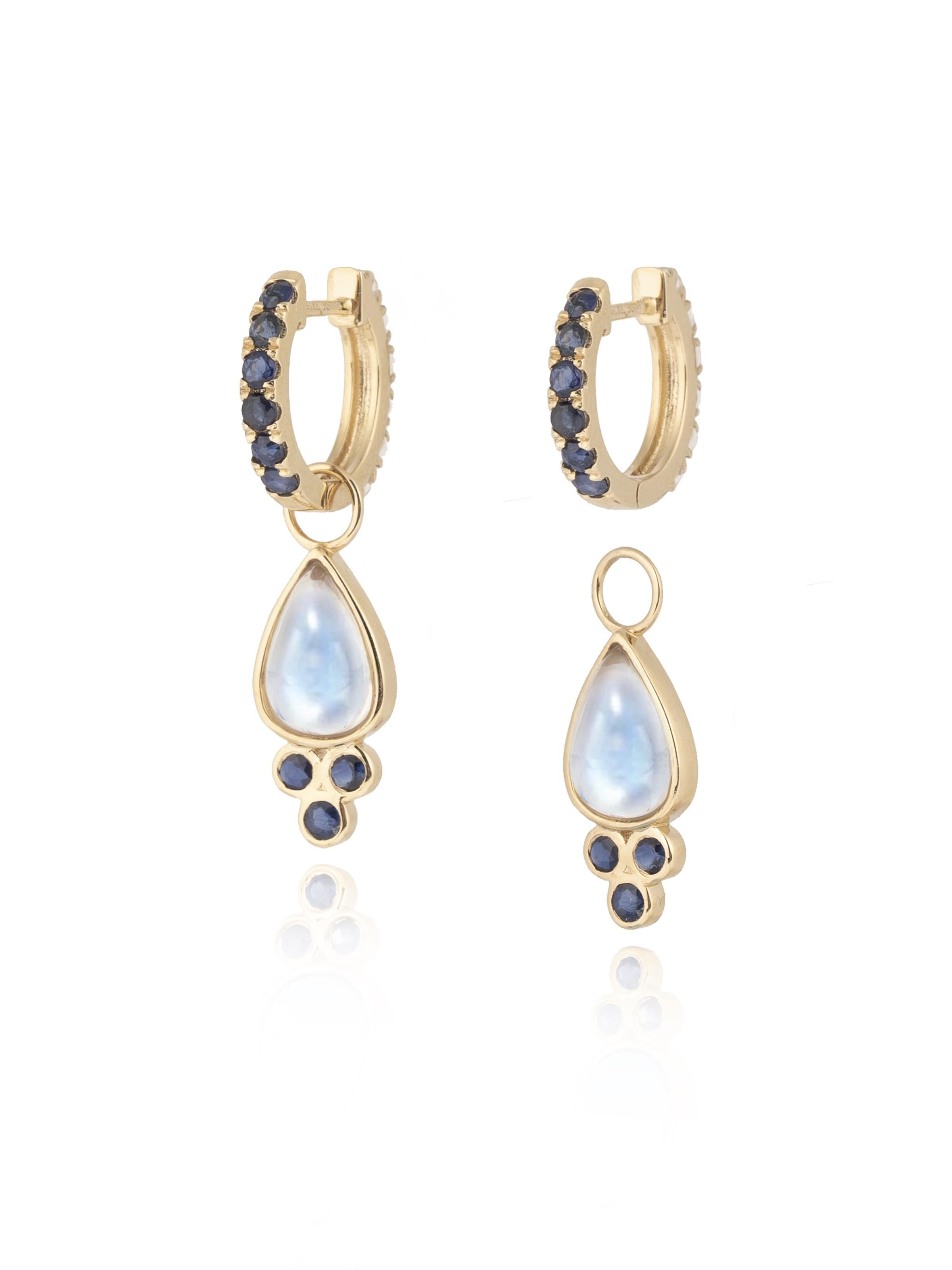 Discover Nina Zhou Sapphire and Moonstone Double-sided Hoop Earrings with Drop Enhancers. These exquisite earrings redefine elegance, featuring a stunning combination of sapphires and moonstone on both sides for a versatile look that's both playful