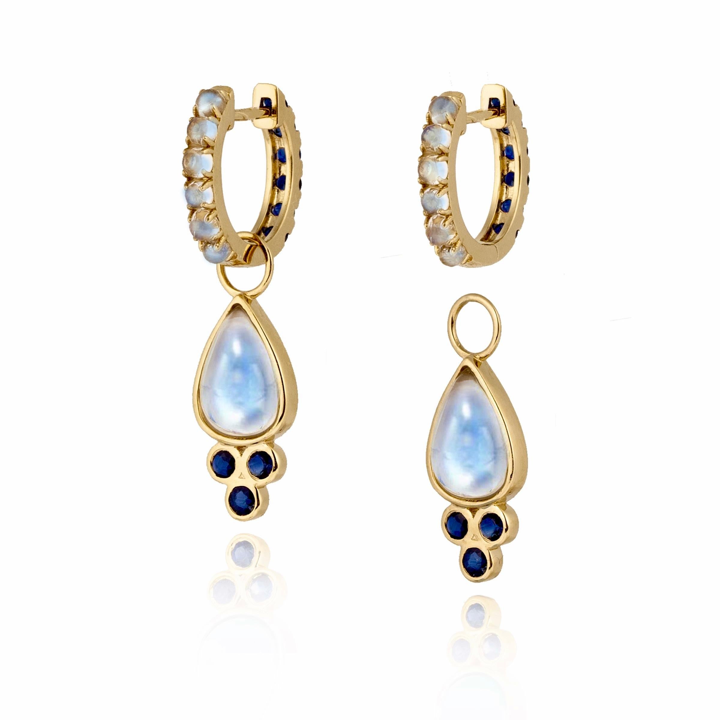 Discover Nina Zhou Sapphire and Moonstone Double-sided Hoop Earrings with Drop Enhancers. These exquisite earrings redefine elegance, featuring a stunning combination of sapphires and moonstone on both sides for a versatile look that's both playful