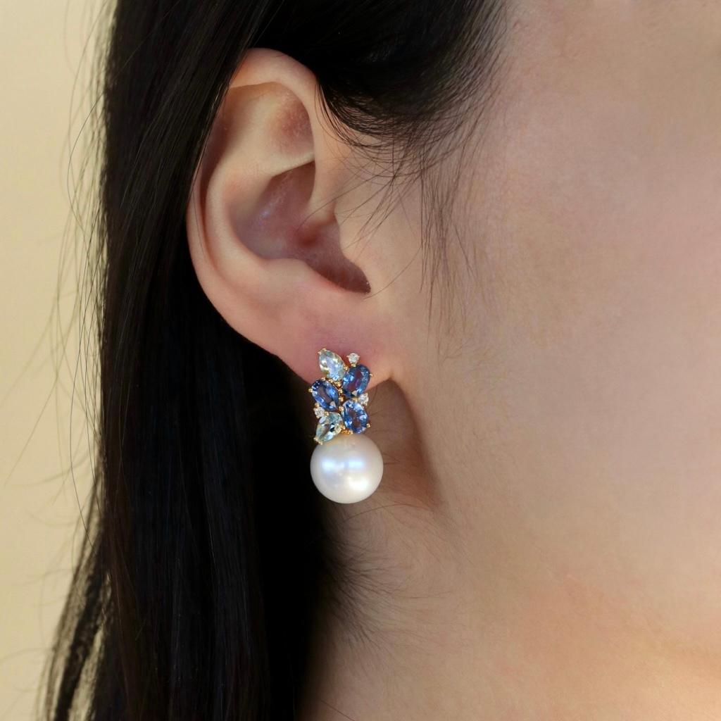 Discover Nina Zhou 5.80ctw Sapphire, Aquamarine and Diamond Cluster Pearl Convertible Drop Earrings in 18k yellow gold, a masterpiece of craftsmanship and elegance. Meticulously set in 18k yellow gold, these earrings feature a breathtaking cluster