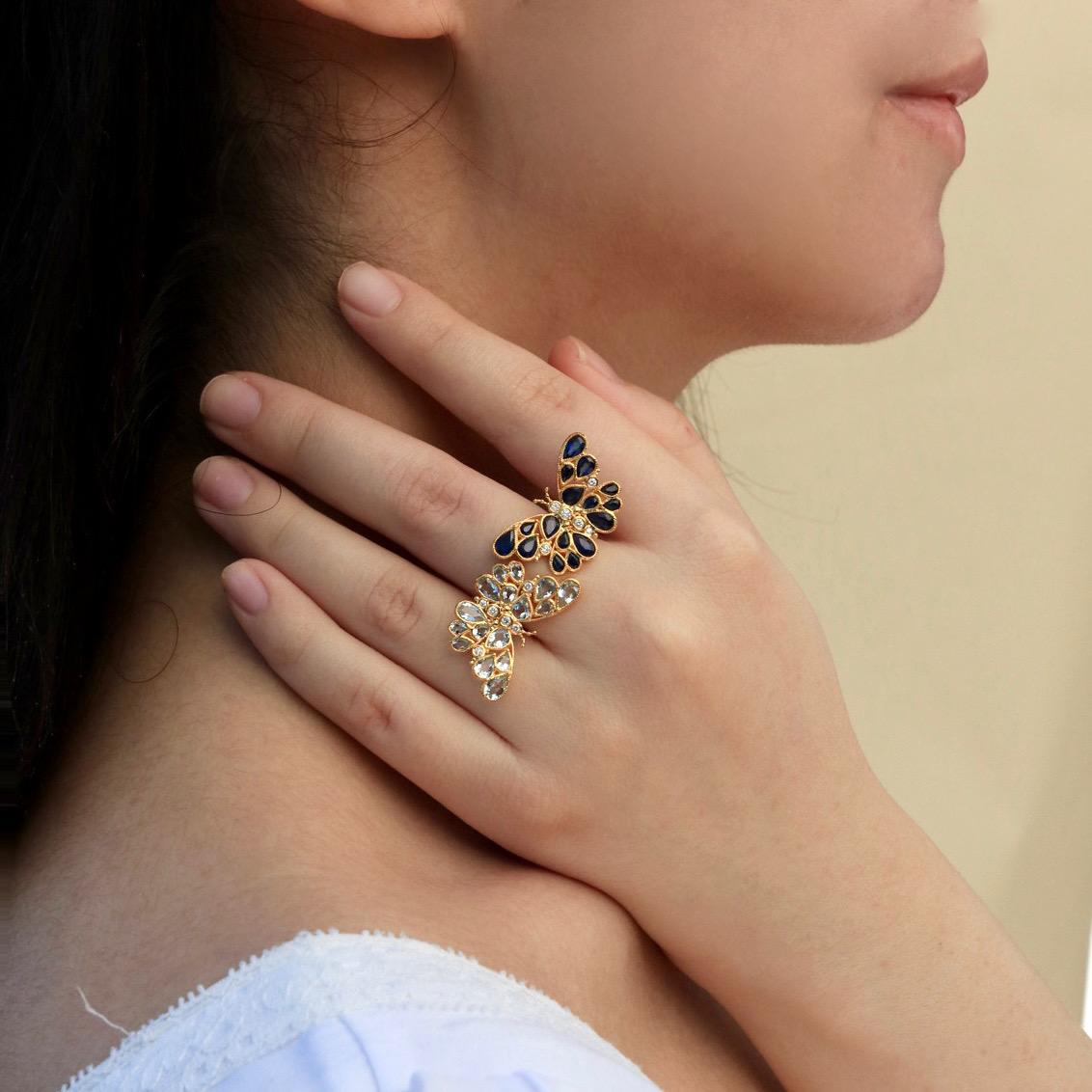 Celebrate the beauty of transformation with the Nina Zhou Sapphire Aquamarine Diamond Two Butterfly Between the Finger Cocktail Ring. Crafted with intricate artistry, this captivating piece features two exquisite butterflies in flight—one adorned