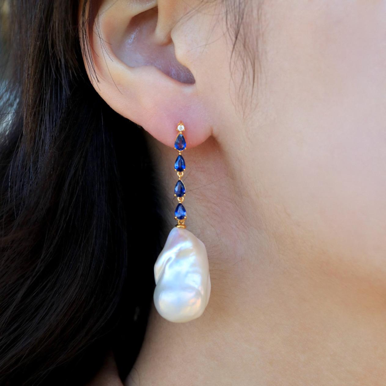 The Nina Zhou Sapphire Diamond Drop and Baroque Pearl Convertible Earrings in 18k Gold are a stunning testament to luxury and versatility. Exquisitely crafted, these earrings feature a harmonious blend of radiant sapphires and sparkling diamonds,