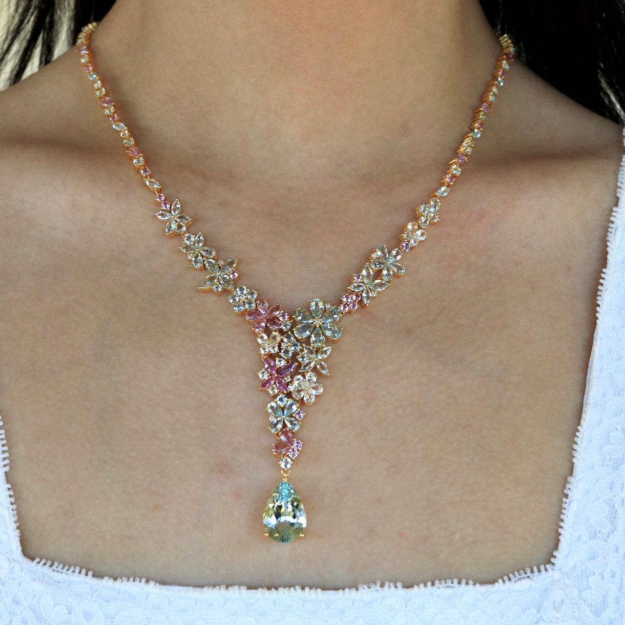 Make a lasting impression with the Nina Zhou Symphony Aquamarine Pink Sapphire Statement Necklace, a masterpiece of artistry and elegance. Cascading with an exquisite blend of aquamarines, pink sapphires, and brilliant diamonds, this necklace