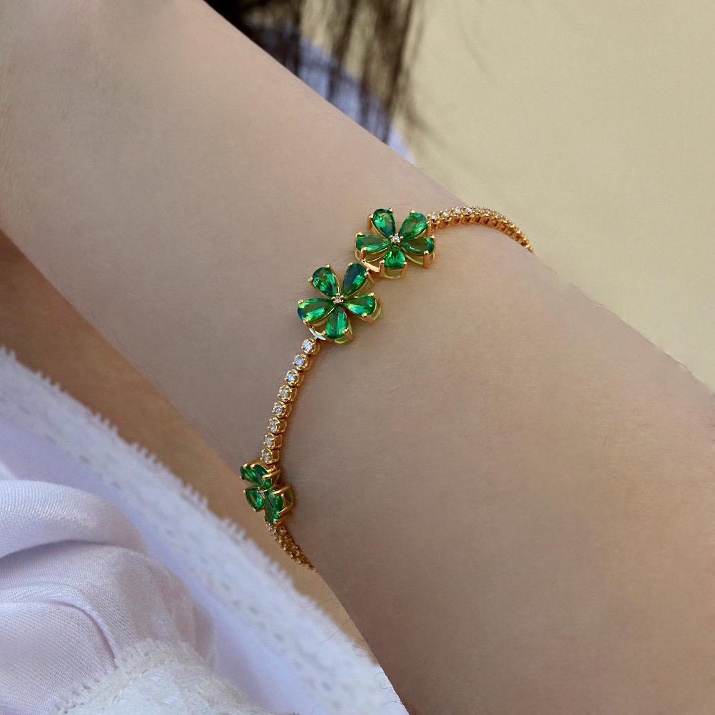 Nina Zhou Tsavorite Cherry Blossom Diamond Tennis Bracelet showcases intricately arranged tsavorite gemstones, each radiating a vibrant green hue that symbolizes renewal and energy. The brilliant diamonds are set to enhance the sparkle and elevate