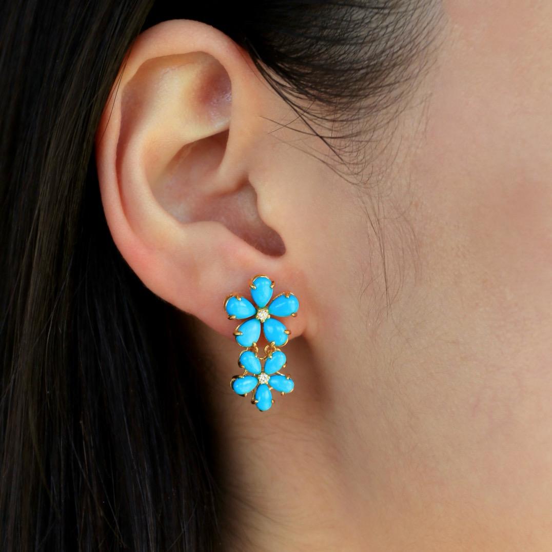 Unveil the enchanting allure of Nina Zhou's 6.12ctw Natural Turquoise Diamond Cherry Blossom Earrings, meticulously crafted in sumptuous 14k yellow gold. These exquisite pieces of jewelry pay homage to the ephemeral beauty of cherry blossoms,