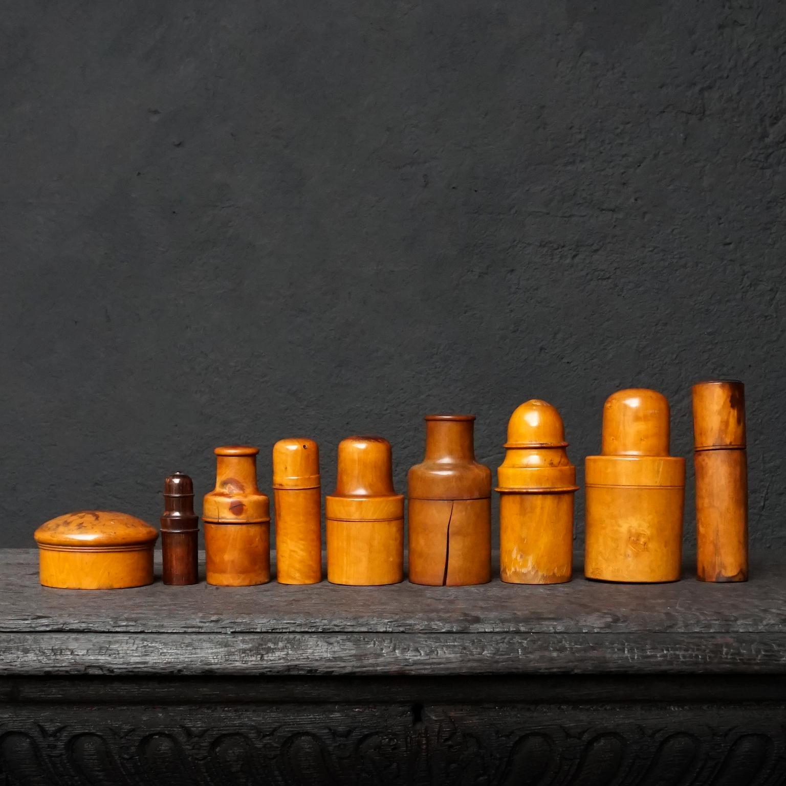 Very decorative medical curiosity cabinet set of nine 19th century Victorian English and German treen turned boxwood bottle holders. 
These containers were used for protecting delicate items such as glass apothecary bottles, perfume bottles,