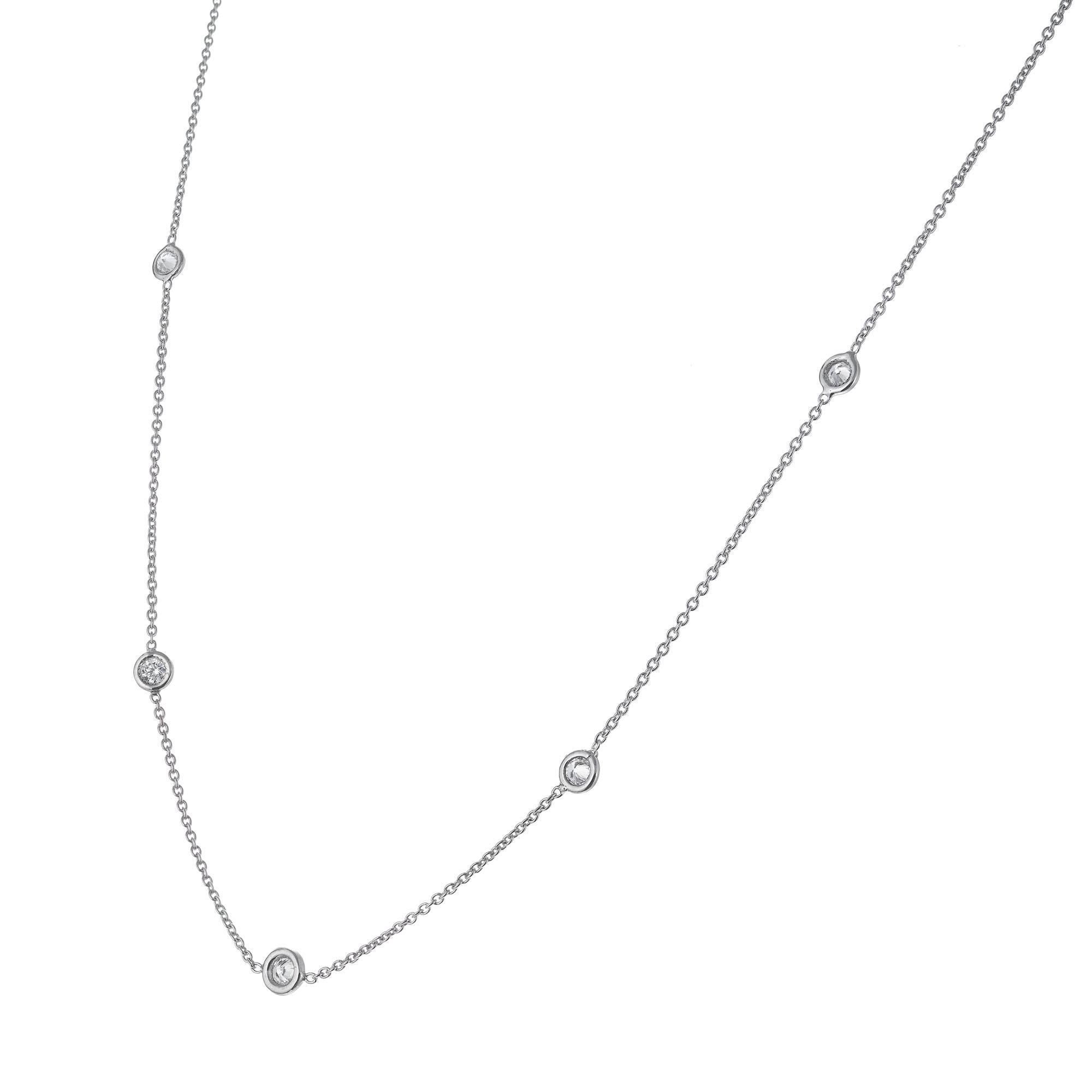 Diamond by the yard, nine round bezel set diamonds 18k white gold 16 inch necklace.

9 round brilliant cut diamonds G-H, VS approx. .81cts
18k white gold 
Stamped: 18k Italy
2.6 grams
Chain: 16 Inches
Width: 3.3mm
Thickness/depth: 1.5mm

