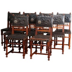 Nine Antique French Renaissance Dragon Embossed Leather and Walnut Chairs