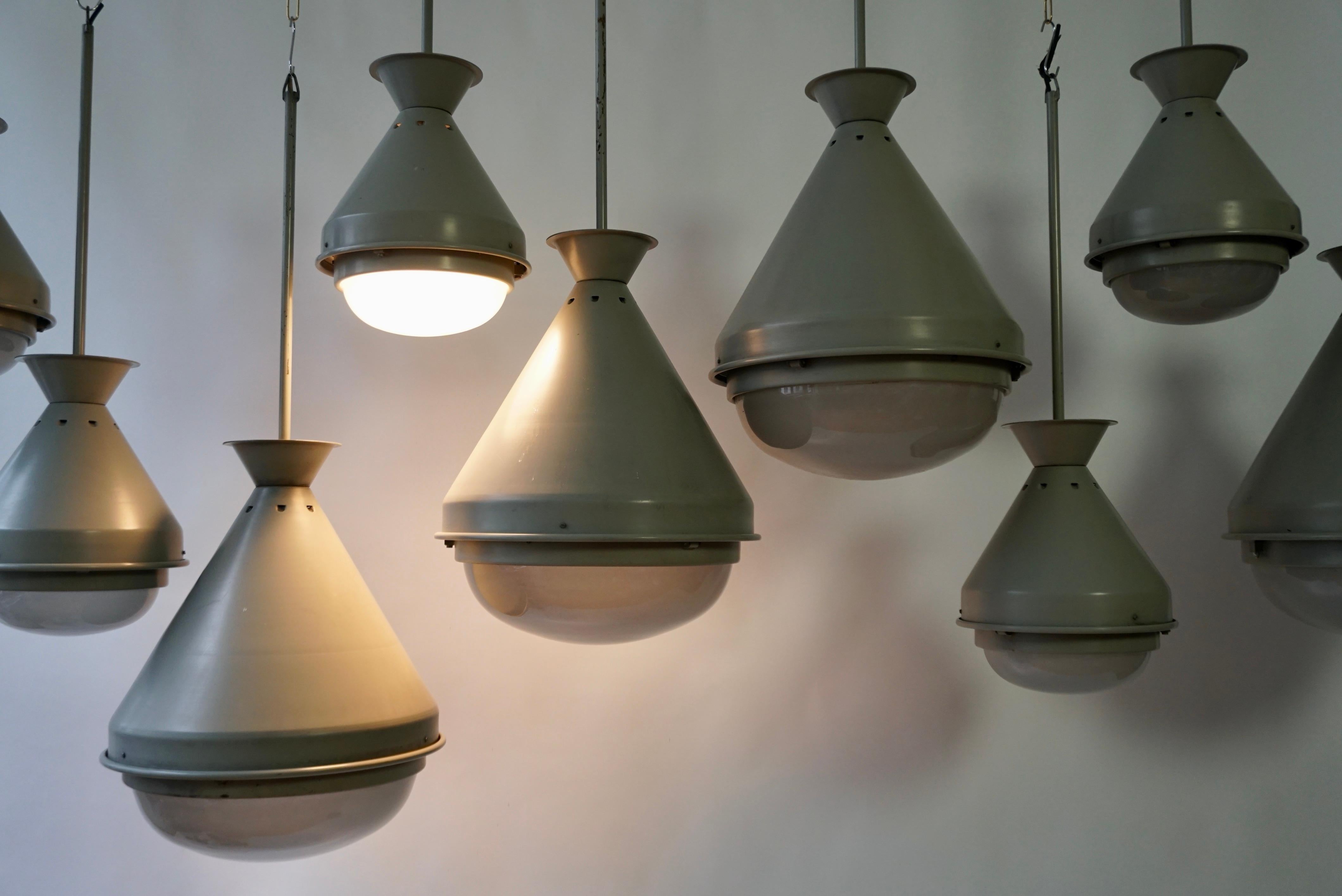 A set of nine beautiful French art deco style conical industrial hanging lamps in gray metal and glass from the 1950s periode.
These elegant lamps come from an old church and are in very good condition.

4 pendant lights;
Diameter 18.1