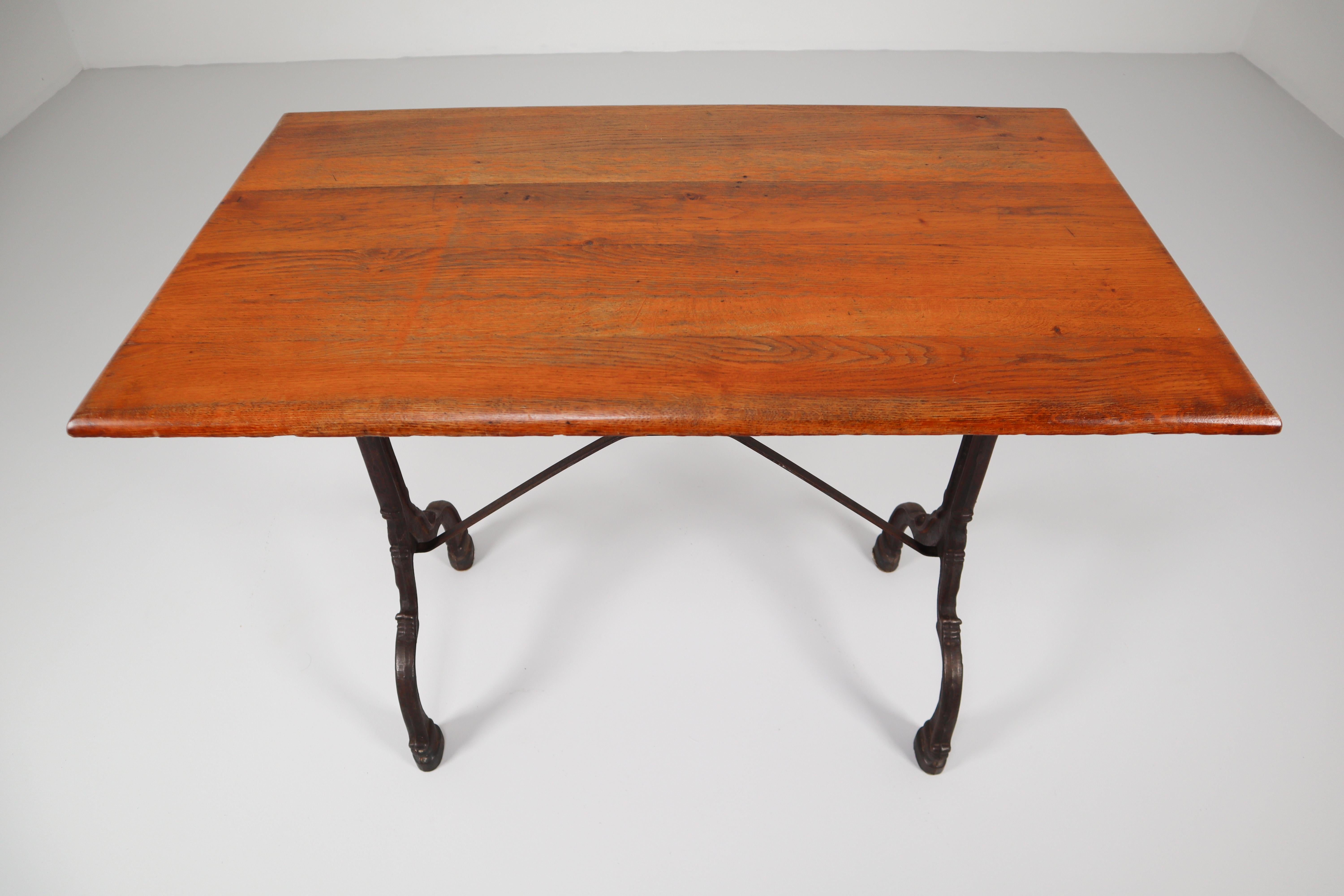 Nine Cast Iron Bistro Tables or Cafe Tables with Patinated Oak Top, France, 1900 6