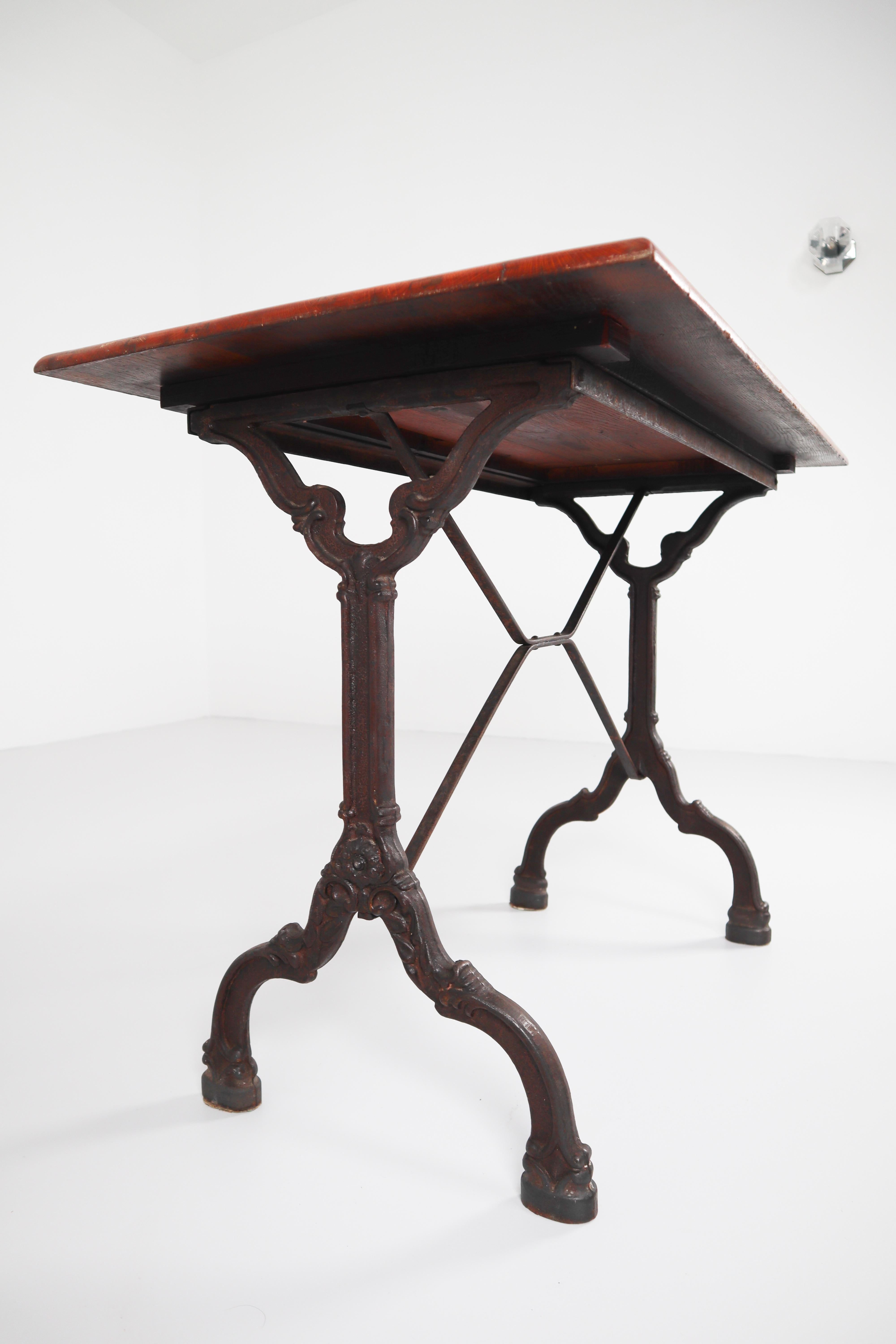 French Nine Cast Iron Bistro Tables or Cafe Tables with Patinated Oak Top, France, 1900