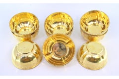 Nine gilded silver washbasins with engraved plant motifs and beaded rims
